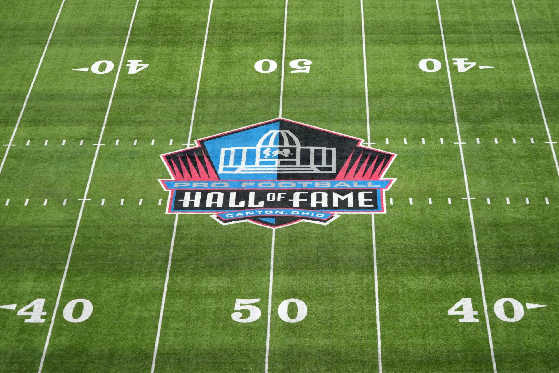 Aug 4, 2022; Canton, Ohio, USA; The Pro Football Hall of Fame logo at midfield at Tom Benson Hall of Fame Stadium.