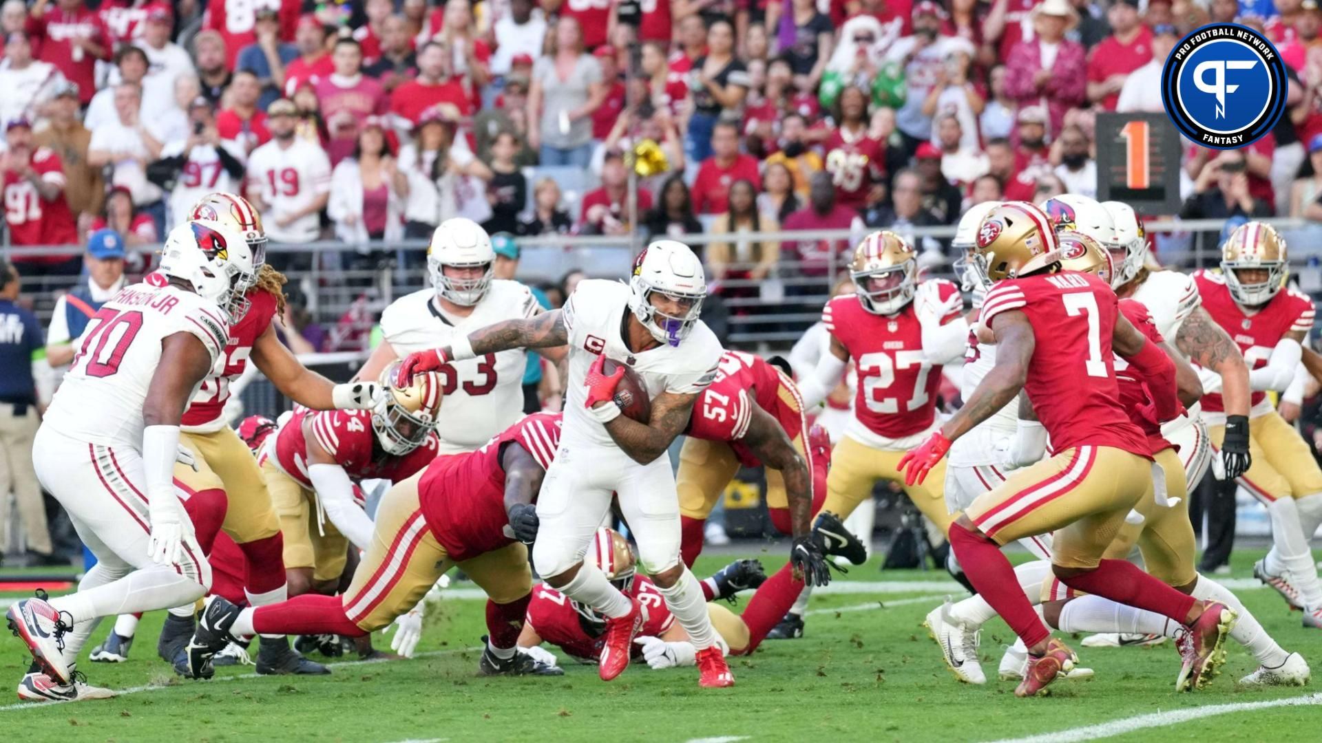 Arizona Cardinals running back James Conner (6) runs with the ball against the San Francisco 49ers during the first half at State Farm Stadium.