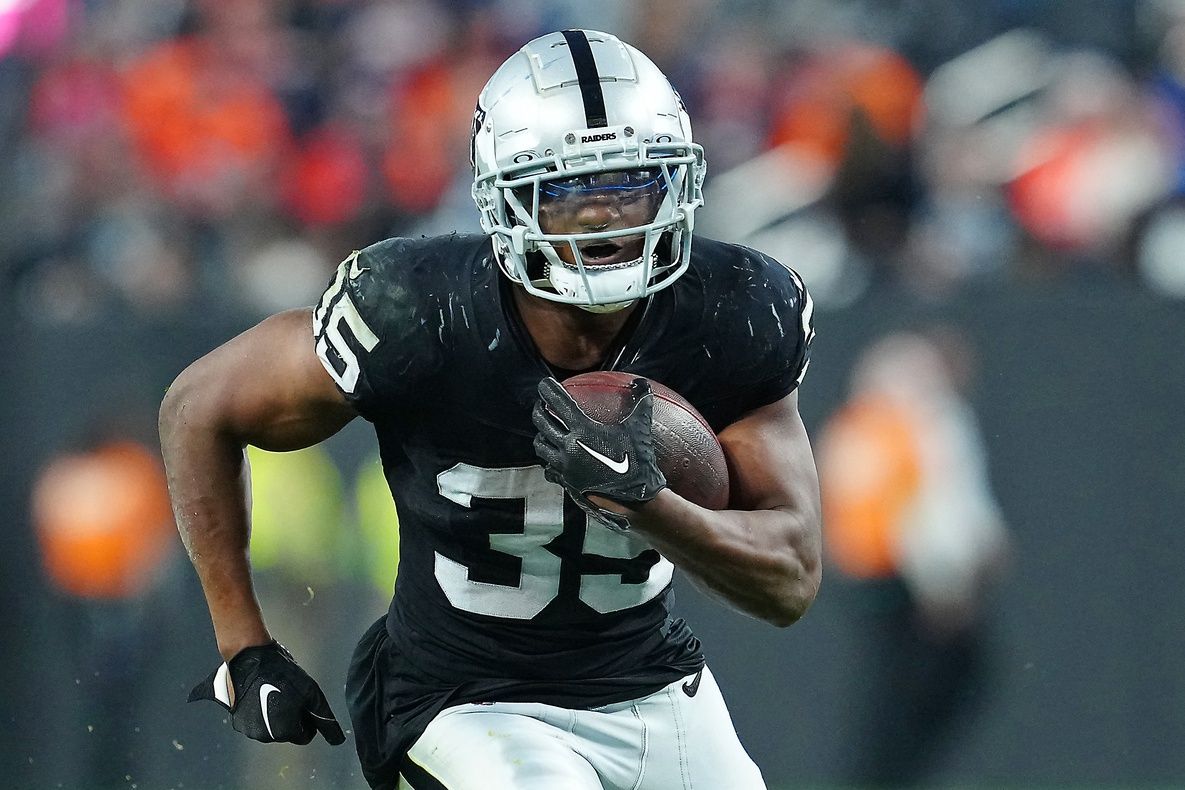 Las Vegas Raiders running back Zamir White (35) gains yardage against the Denver Broncos during the fourth quarter at Allegiant Stadium. Mandatory Credit: Stephen R. Sylvanie-USA TODAY Sports