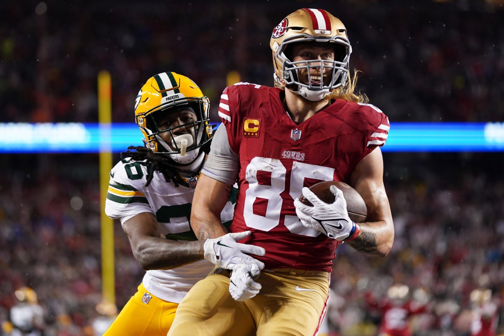 San Francisco 49ers tight end George Kittle (85) scores a touchdown against Green Bay Packers safety Darnell Savage (26) during the second quarter in a 2024 NFC divisional round game at Levi's Stadium. Kittle ranks highly on PFN's NFL Top 100 list. Mandatory Credit: Kyle Terada-USA TODAY Sports