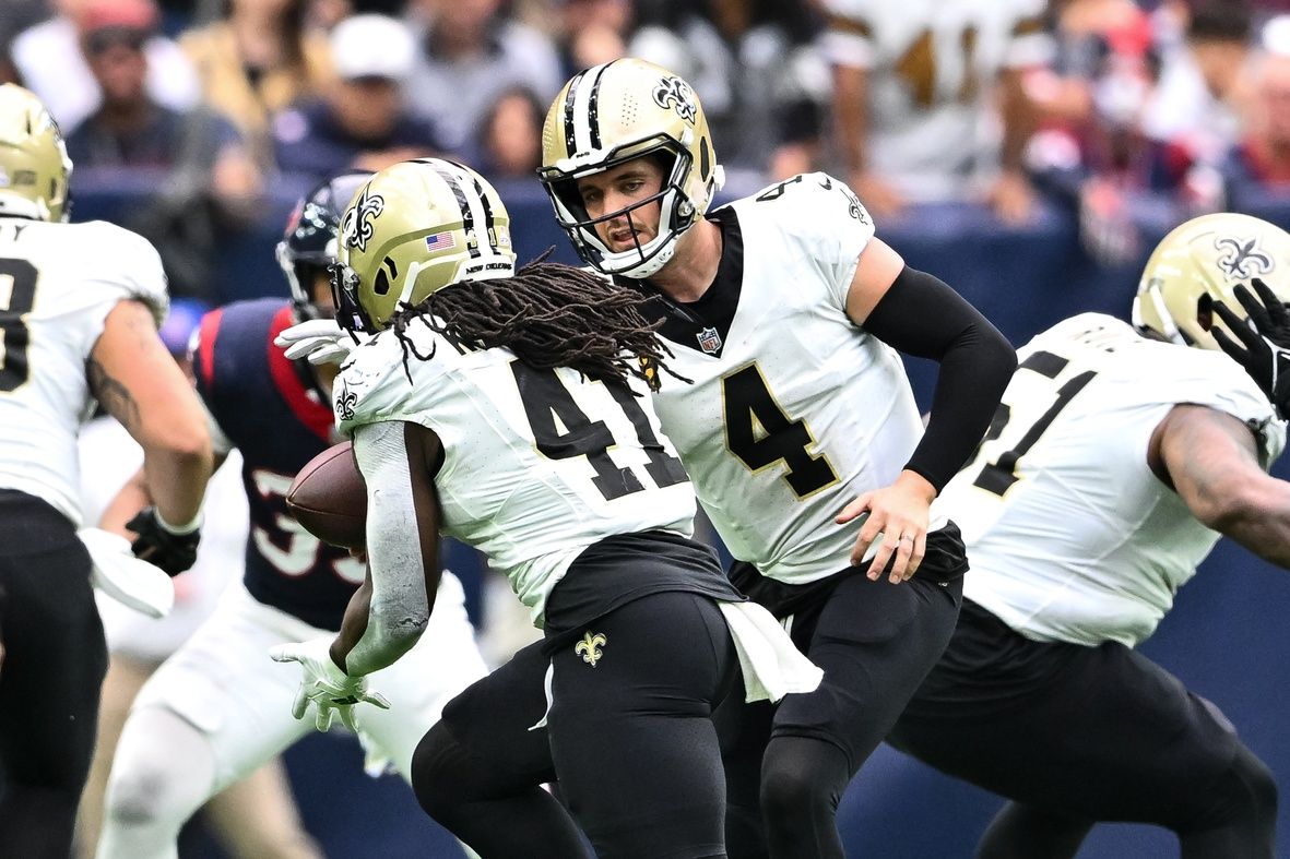 New Orleans Saints quarterback Derek Carr (4) hands off the ball to running back Alvin Kamara (41) during the fourth quarter against the Houston Texans at NRG Stadium.