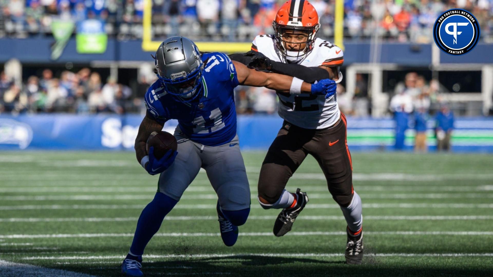 Seattle Seahawks wide receiver Jaxon Smith-Njigba (11) carries the ball after a catch while chased by Cleveland Browns safety Grant Delpit (22) at Lumen Field.