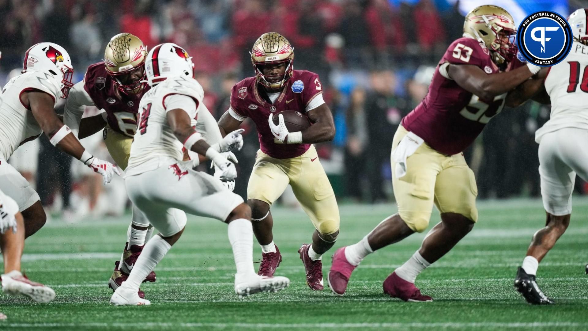 Florida State Seminoles running back Trey Benson (3) runs the ball against the Louisville Cardinals during the fourth quarter at Bank of America Stadium.