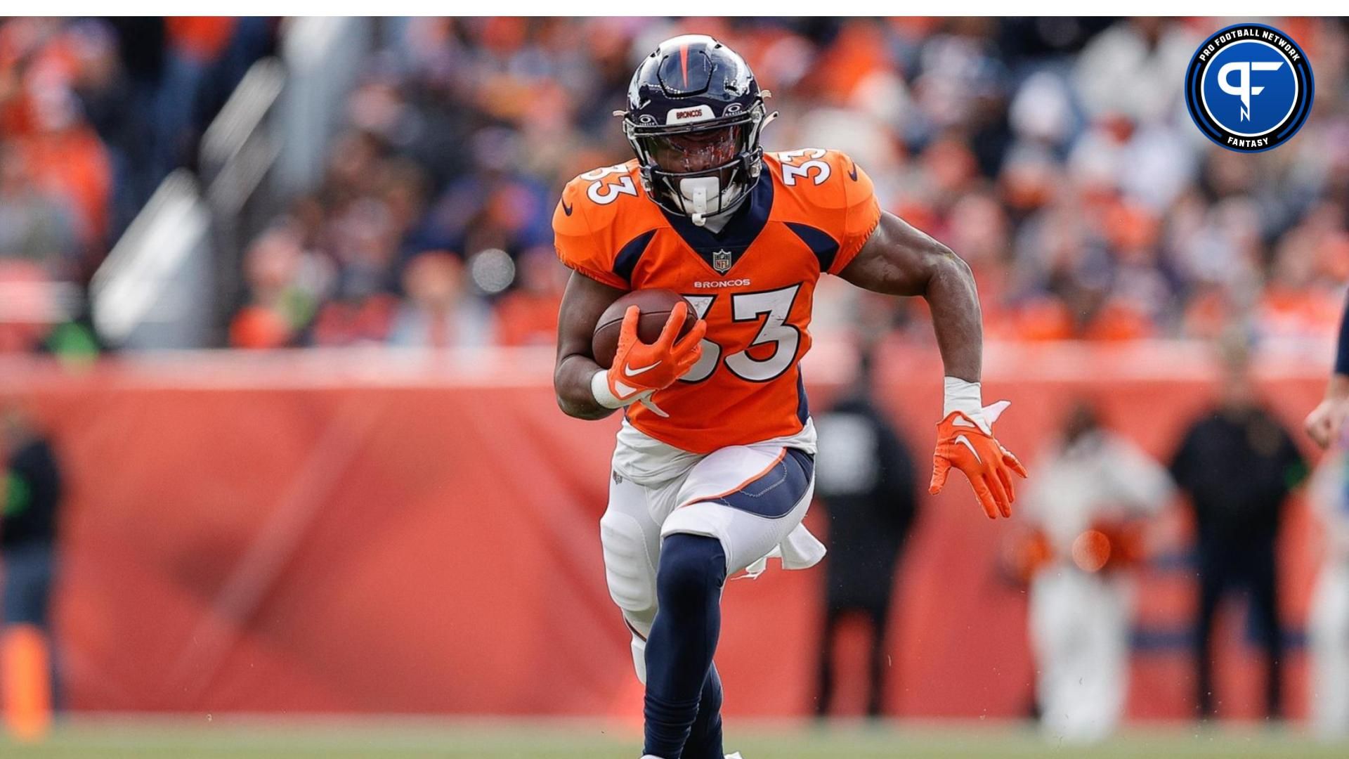 Denver Broncos running back Javonte Williams (33) runs the ball in the first quarter against the Los Angeles Chargers at Empower Field at Mile High. Mandatory Credit: Isaiah J. Downing-USA TODAY Sports