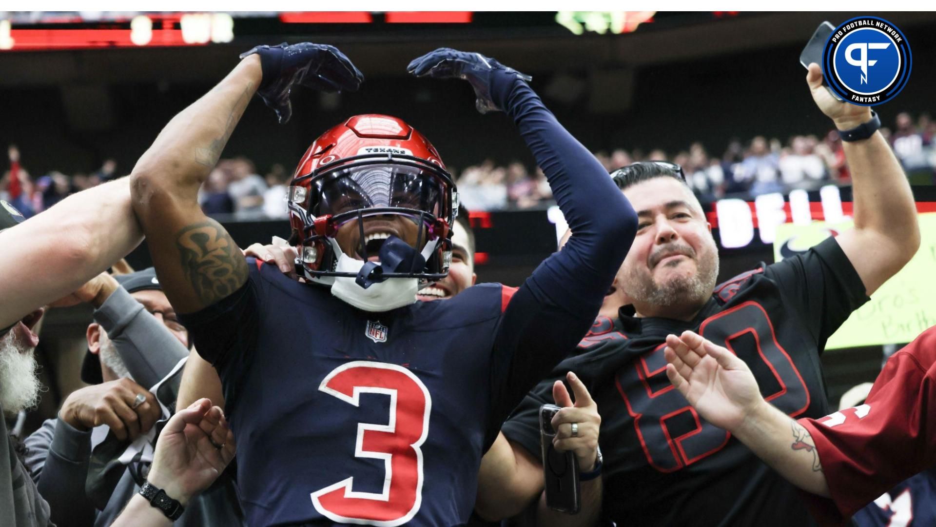 Houston Texans wide receiver Tank Dell (3) jumps in the stands and celebrates his touchdown against the Arizona Cardinals in the second quarter at NRG Stadium. Mandatory Credit: Thomas Shea-USA