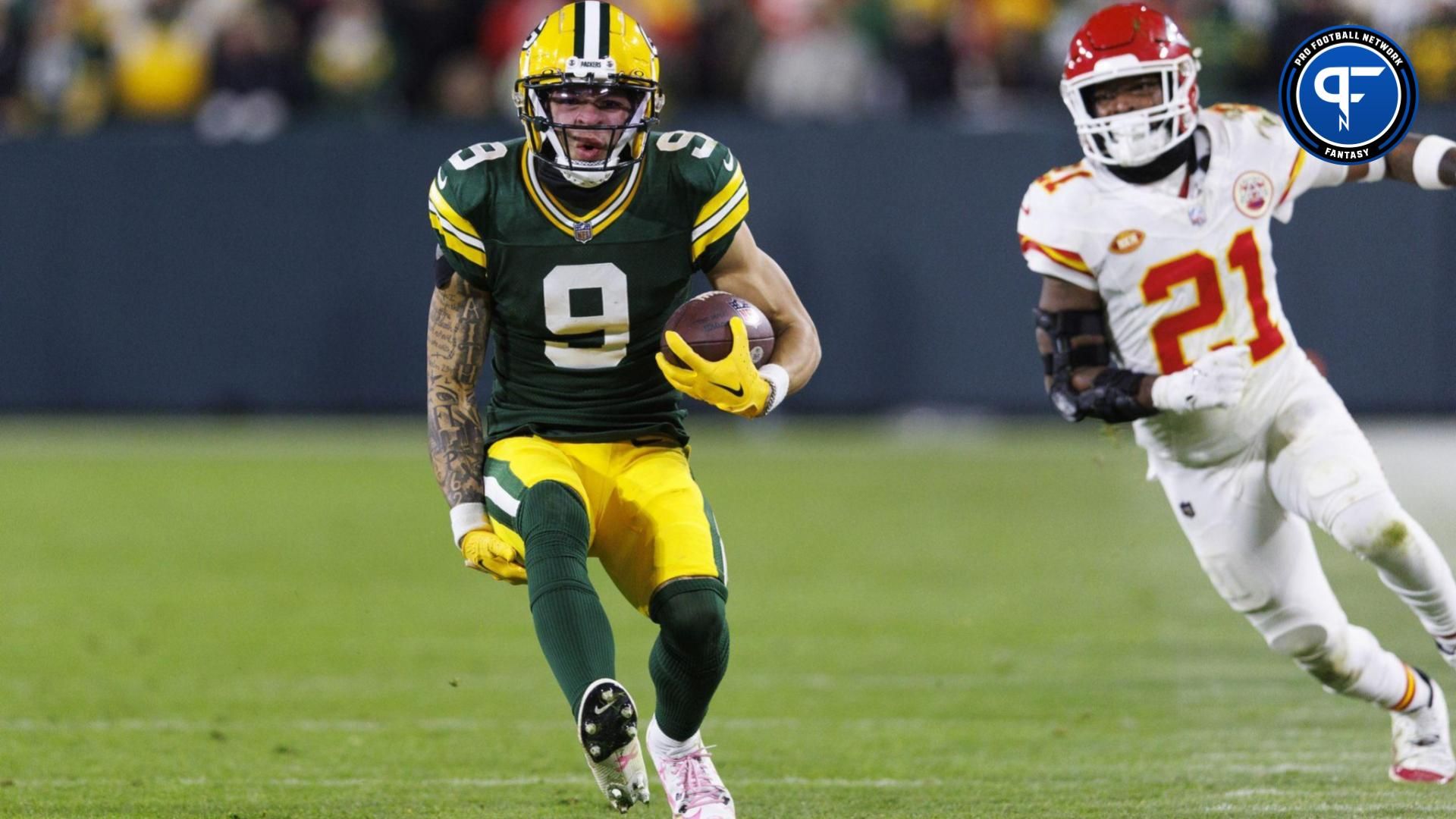 Green Bay Packers wide receiver Christian Watson (9) reaches for his right leg while carrying the football during the fourth quarter against the Kansas City Chiefs at Lambeau Field.