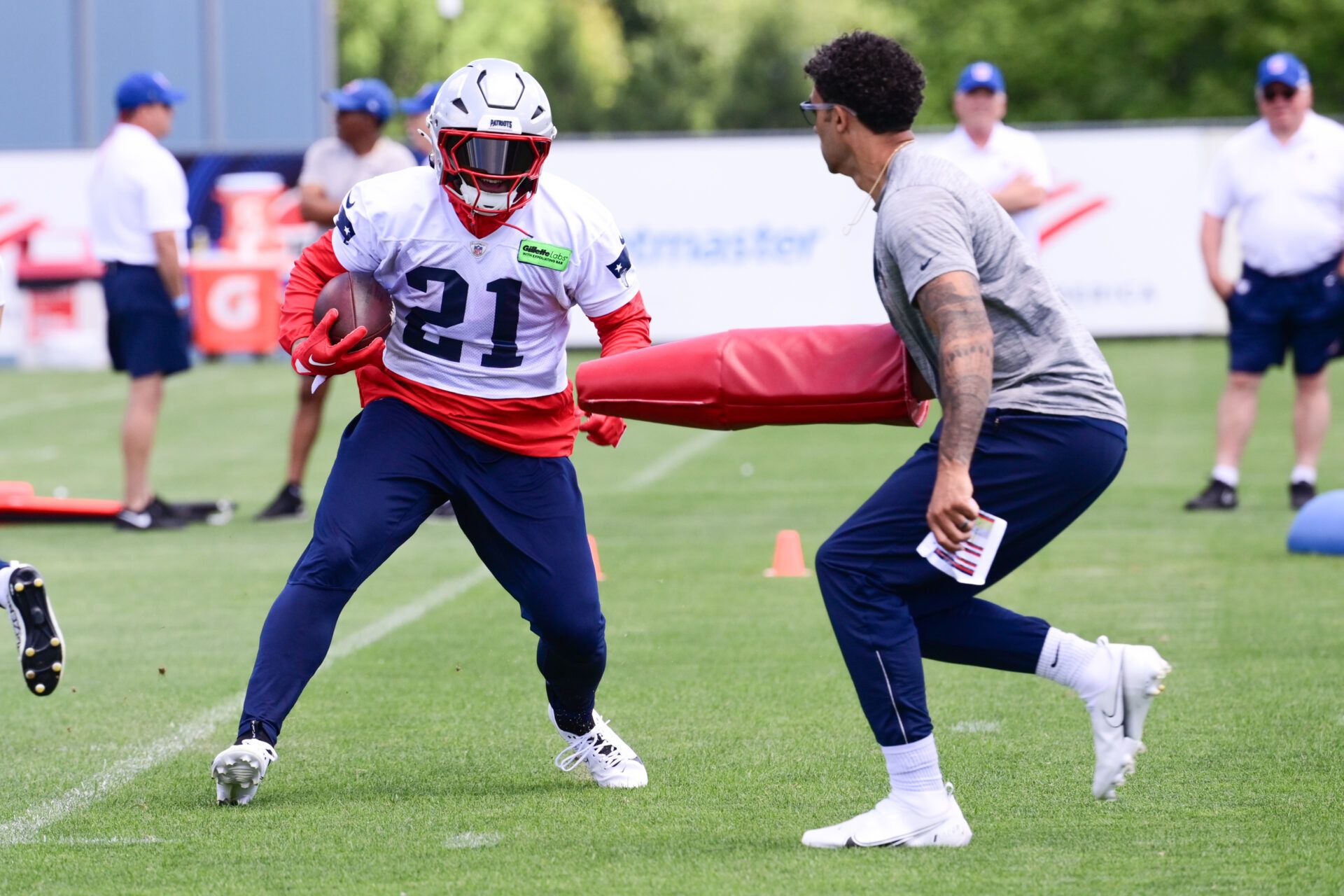 Jun 10, 2024; Foxborough, MA, USA; New England Patriots running back Antonio Gibson (21) runs through a drill at minicamp at Gillette Stadium. Mandatory Credit: Eric Canha-USA TODAY Sports