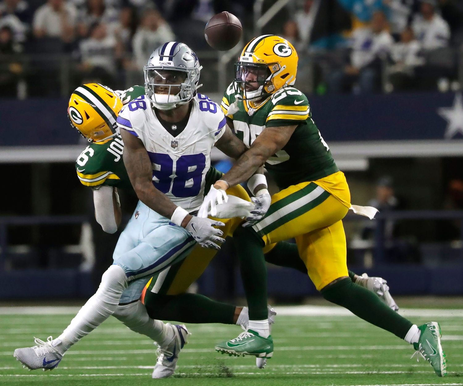 Green Bay Packers cornerback Keisean Nixon (25) and Green Bay Packers safety Anthony Johnson Jr. (36) break up a pass intended for Dallas Cowboys wide receiver CeeDee Lamb (88) during the fourth quarter of their wild card playoff game Sunday, January 14, 2024 at AT&T Stadium in Arlington, Texas