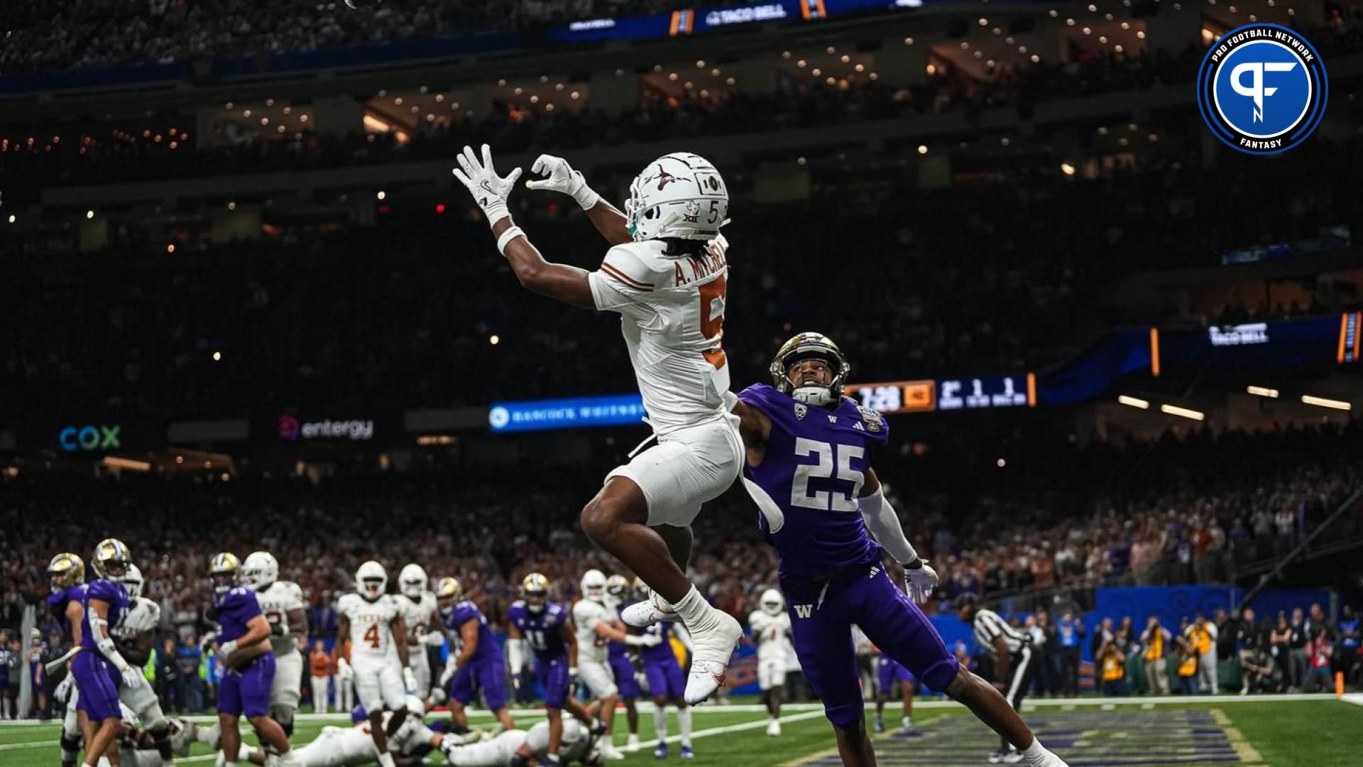 Texas Longhorns wide receiver Adonai Mitchell (5) makes a touchdown catch over Washington cornerback Elijah Jackson during the Sugar Bowl College Football Playoff semifinals game at the Caesars Superdome on Monday, Jan. 1, 2024 in New Orleans, Louisiana. The catch would be the last touchdown for the Longhorns in the 31-37 loss to Washington.