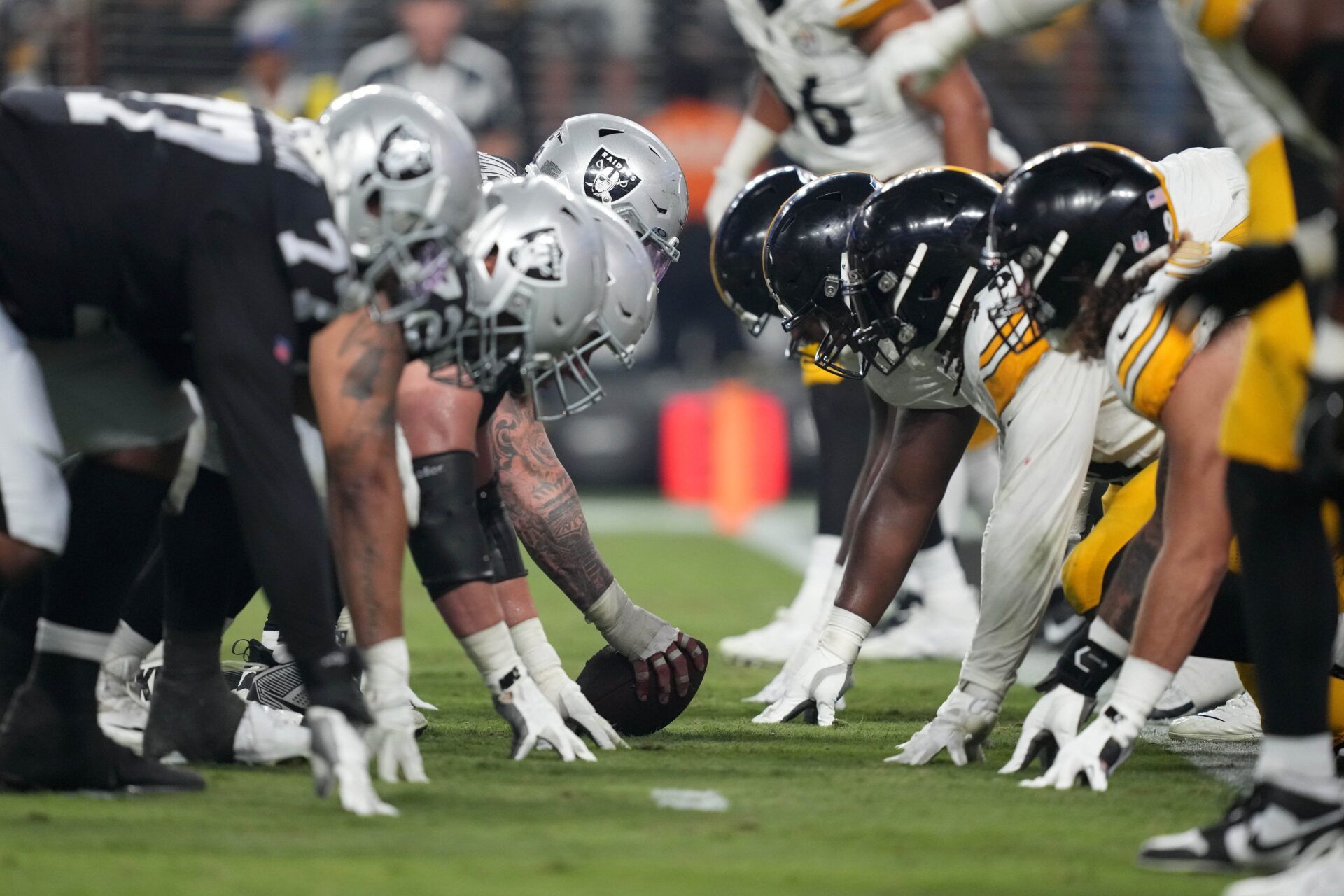 A general overall view of helmets at the line of scrimmage as Las Vegas Raiders center Andre James (68) snaps the ball against the Pittsburgh Steelers at Allegiant Stadium. Could we see an NFL 18-game schedule soon? Mandatory Credit: Kirby Lee-USA TODAY Sports