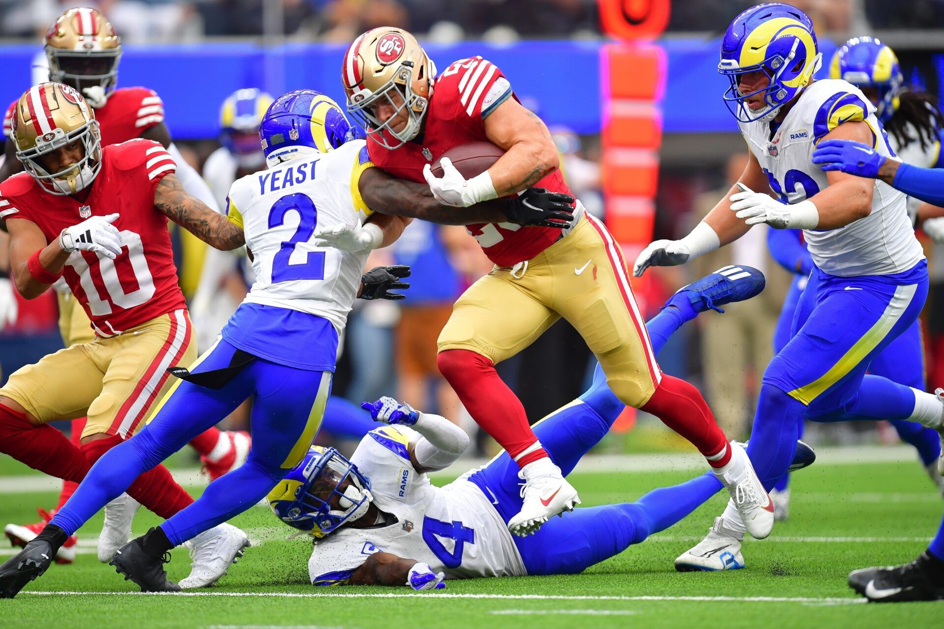 San Francisco 49ers running back Christian McCaffrey (23) runs the ball for a touchdown against Los Angeles Rams safety Russ Yeast (2) and safety Jordan Fuller (4) during the first half at SoFi Stadium. The 49ers have a tough NFL strength of schedule for the 2024 season. Mandatory Credit: Gary A. Vasquez-USA TODAY Sports