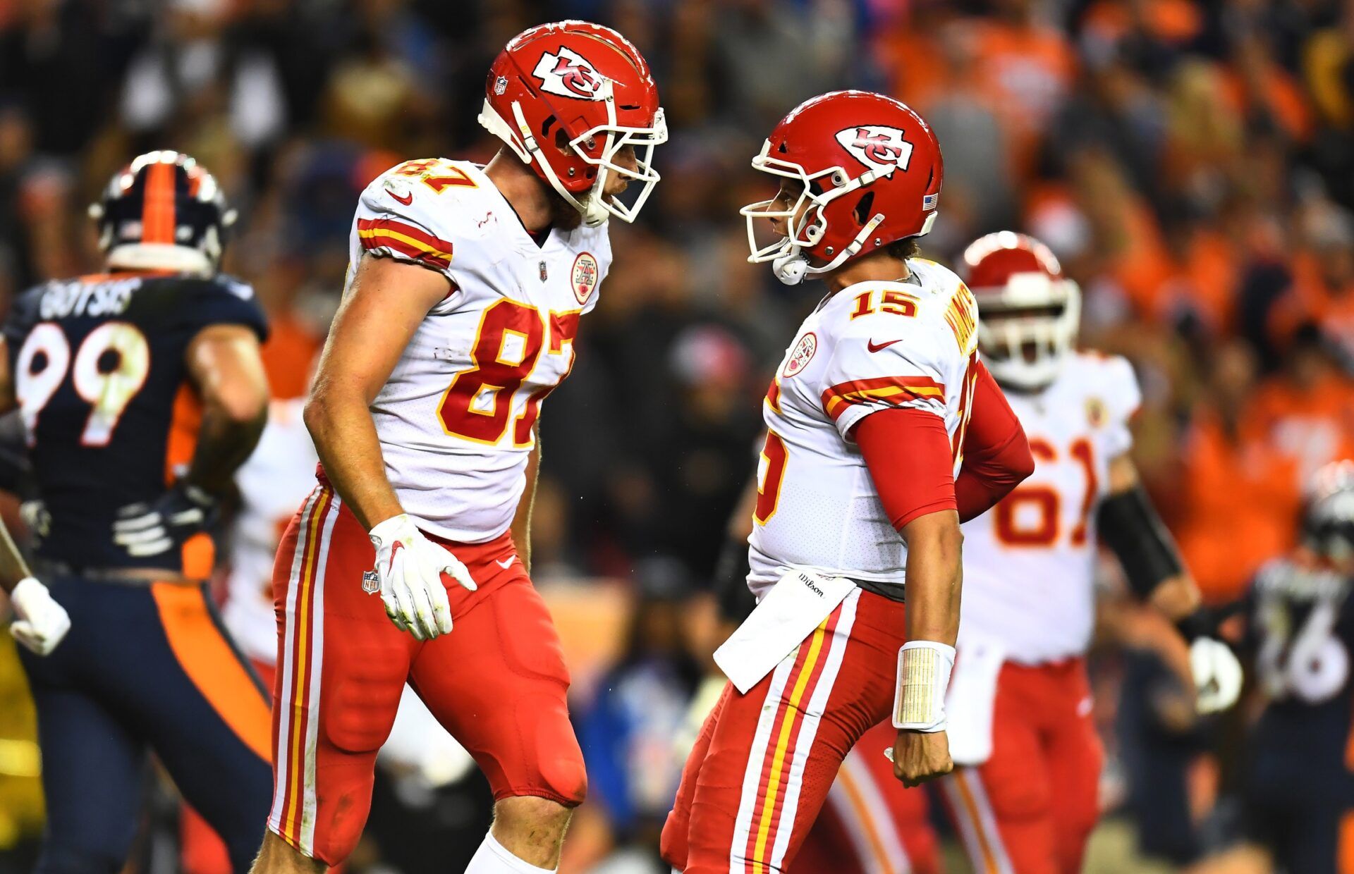 Kansas City Chiefs tight end Travis Kelce (87) celebrates with quarterback Patrick Mahomes (15) after making a touchdown reception against the Denver Broncos in the fourth quarter at Broncos Stadium at Mile High. Where is the Chiefs' NFL strength of schedule ranking in 2024? Mandatory Credit: Ron Chenoy-USA TODAY Sports