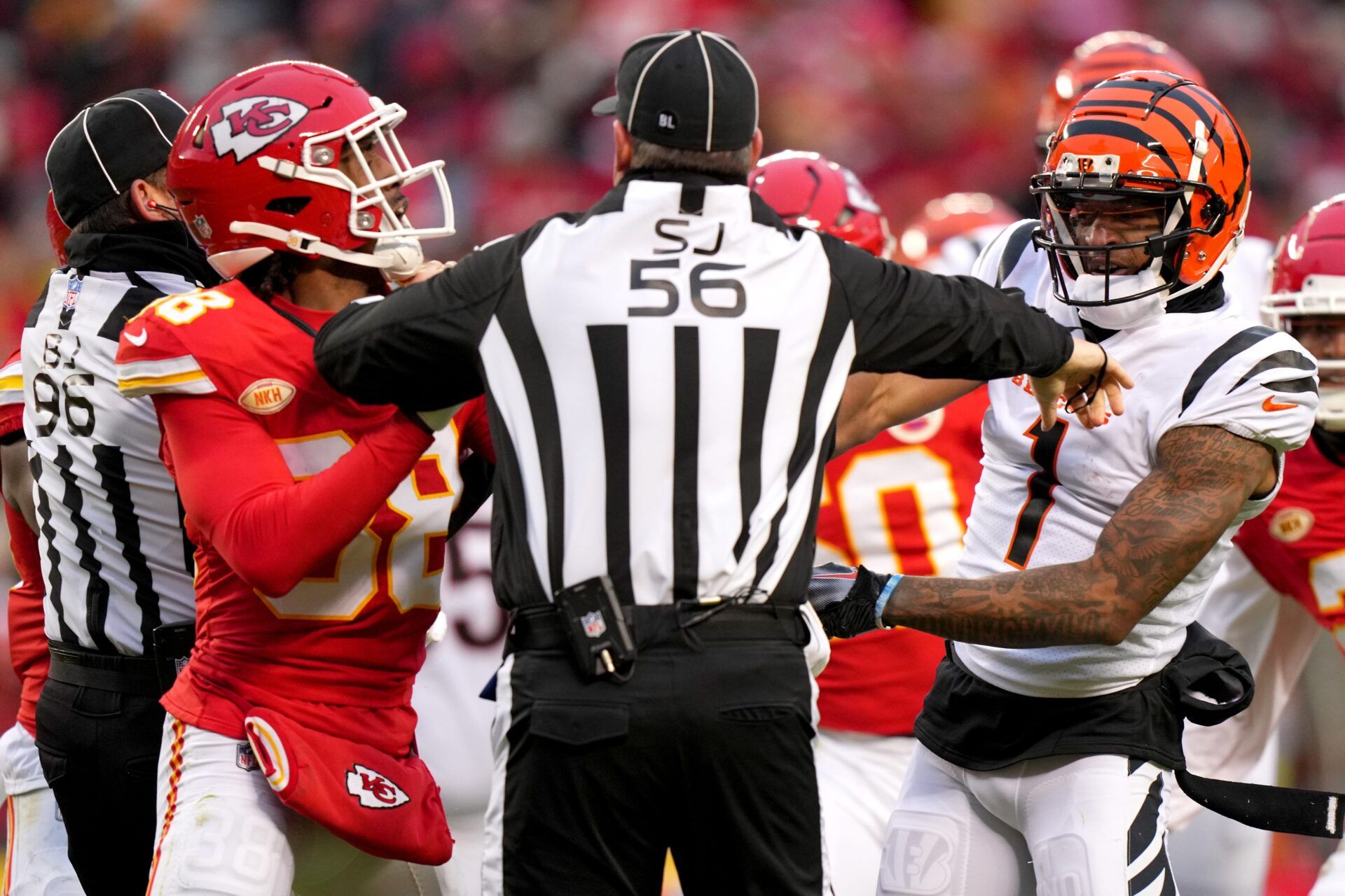 Side judge Allen Baynes (56) separates Kansas City Chiefs cornerback L'Jarius Sneed (38), left and Cincinnati Bengals wide receiver Ja'Marr Chase (1), right, in the second quarter during a Week 17 NFL football game between the Cincinnati Bengals and the Kansas City Chiefs, Sunday, Dec. 31, 2023, at GEHA Field at Arrowhead Stadium in Kansas City, Mo.