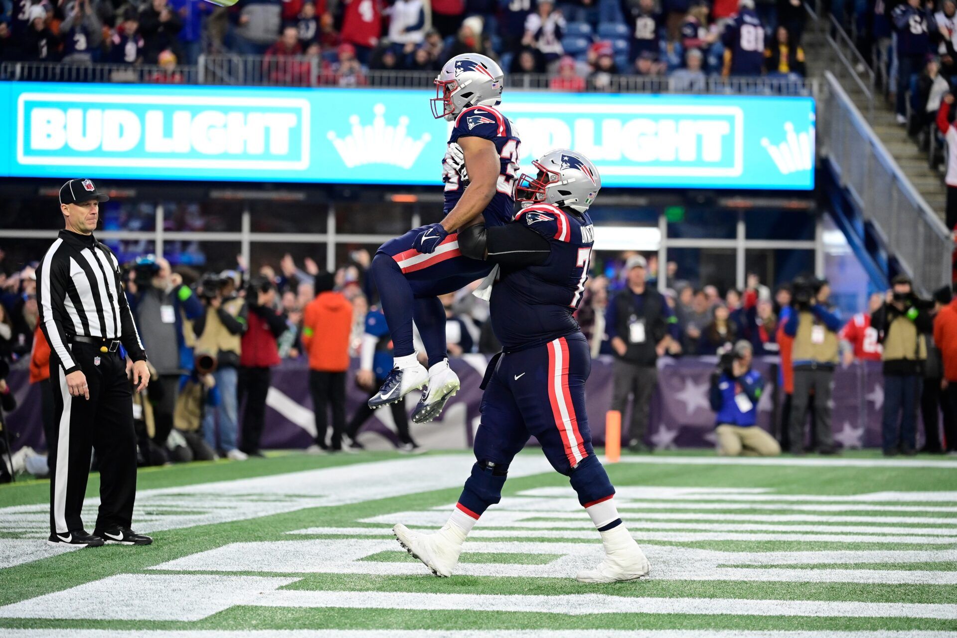 New England Patriots running back Kevin Harris (36) is carried by guard Mike Onwenu (71) after scoring a touchdown against the Kansas City Chiefs during the second half at Gillette Stadium.
