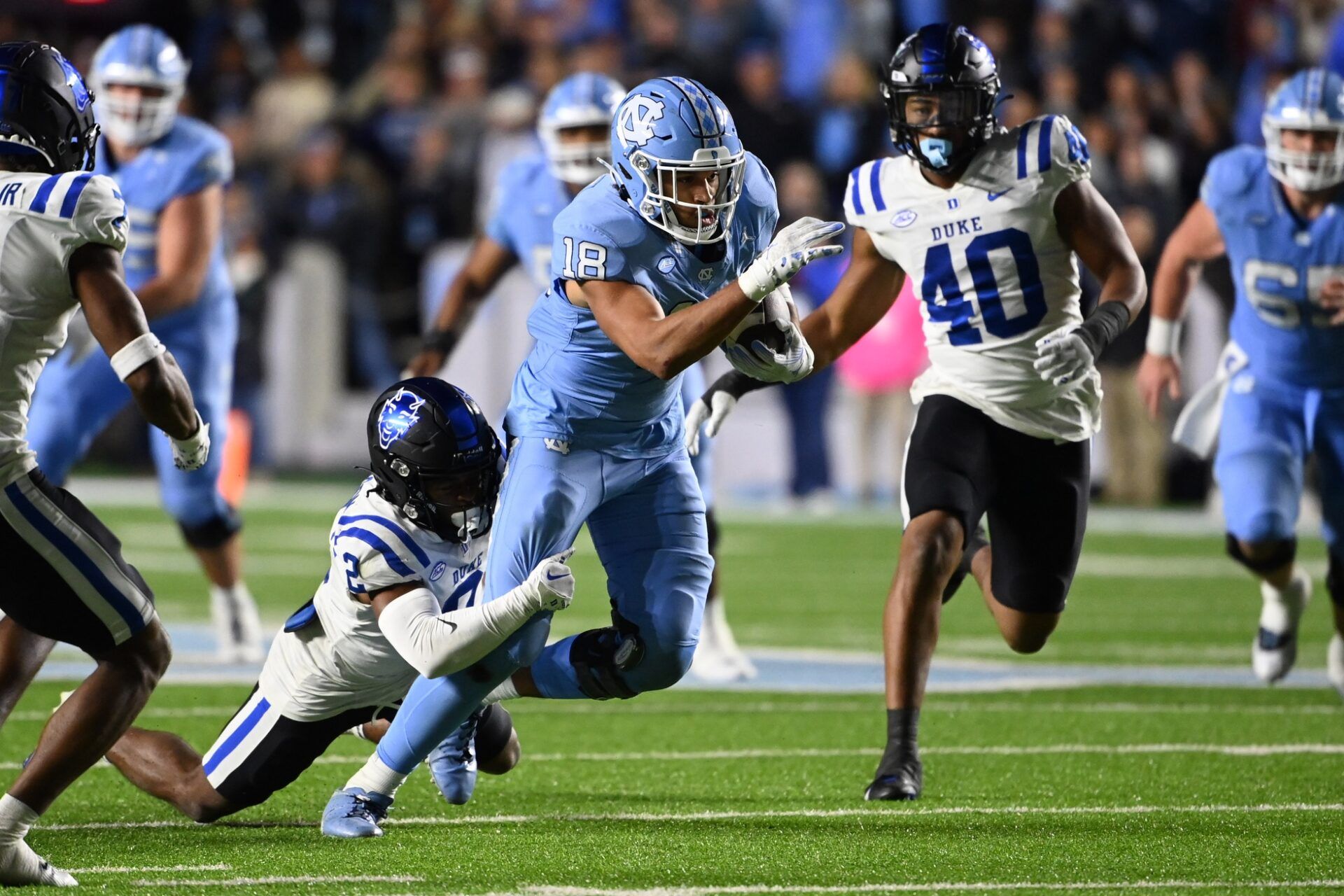 North Carolina Tar Heels tight end Bryson Nesbit (18) catches the ball as Duke Blue Devils safety Jaylen Stinson (2) defends to set up a field goal attempt at the end of the fourth quarter at Kenan Memorial Stadium.