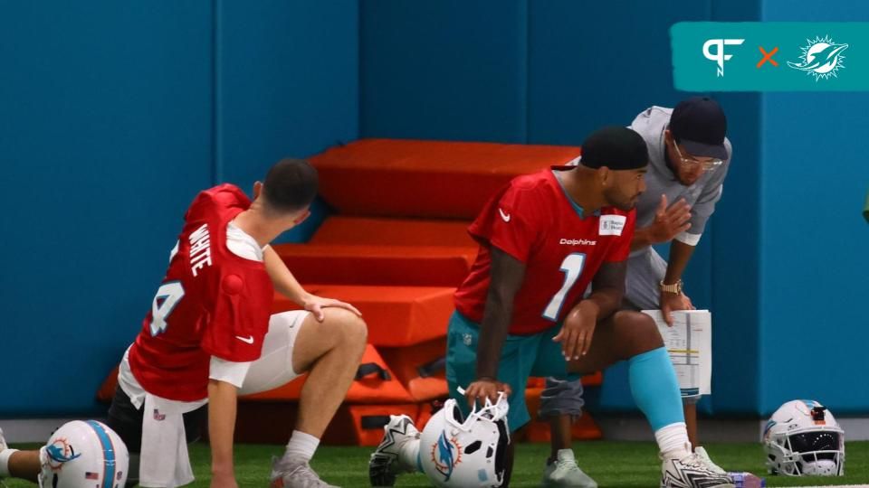 Miami Dolphins head coach Mike McDaniel talks to quarterback Tua Tagovailoa (1) during training camp at Baptist Health Training Complex.