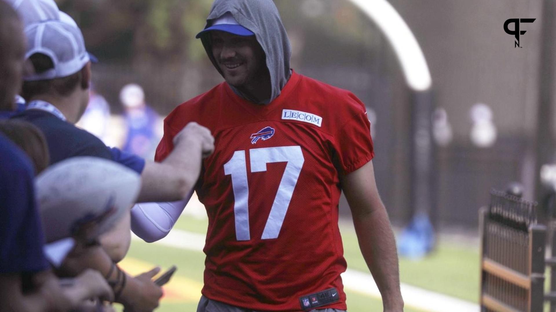 Buffalo Bills QB Josh Allen (17) shakes hands and fist bumps fans as he heads for the field.