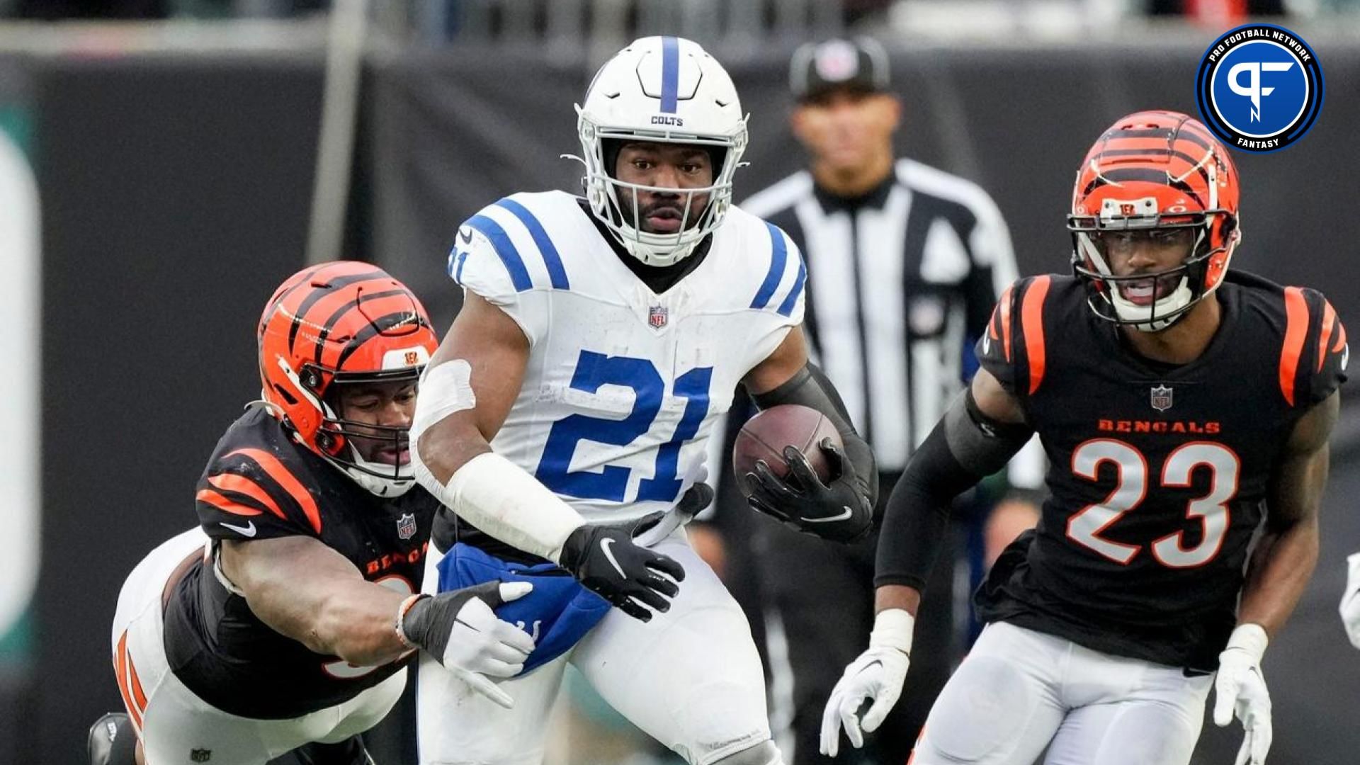 Cincinnati Bengals defensive tackle BJ Hill (92) dives to bring down Indianapolis Colts running back Zack Moss (21) on Sunday, Dec. 10, 2023, during a game against the Cincinnati Bengals at Paycor Stadium in Cincinnati.