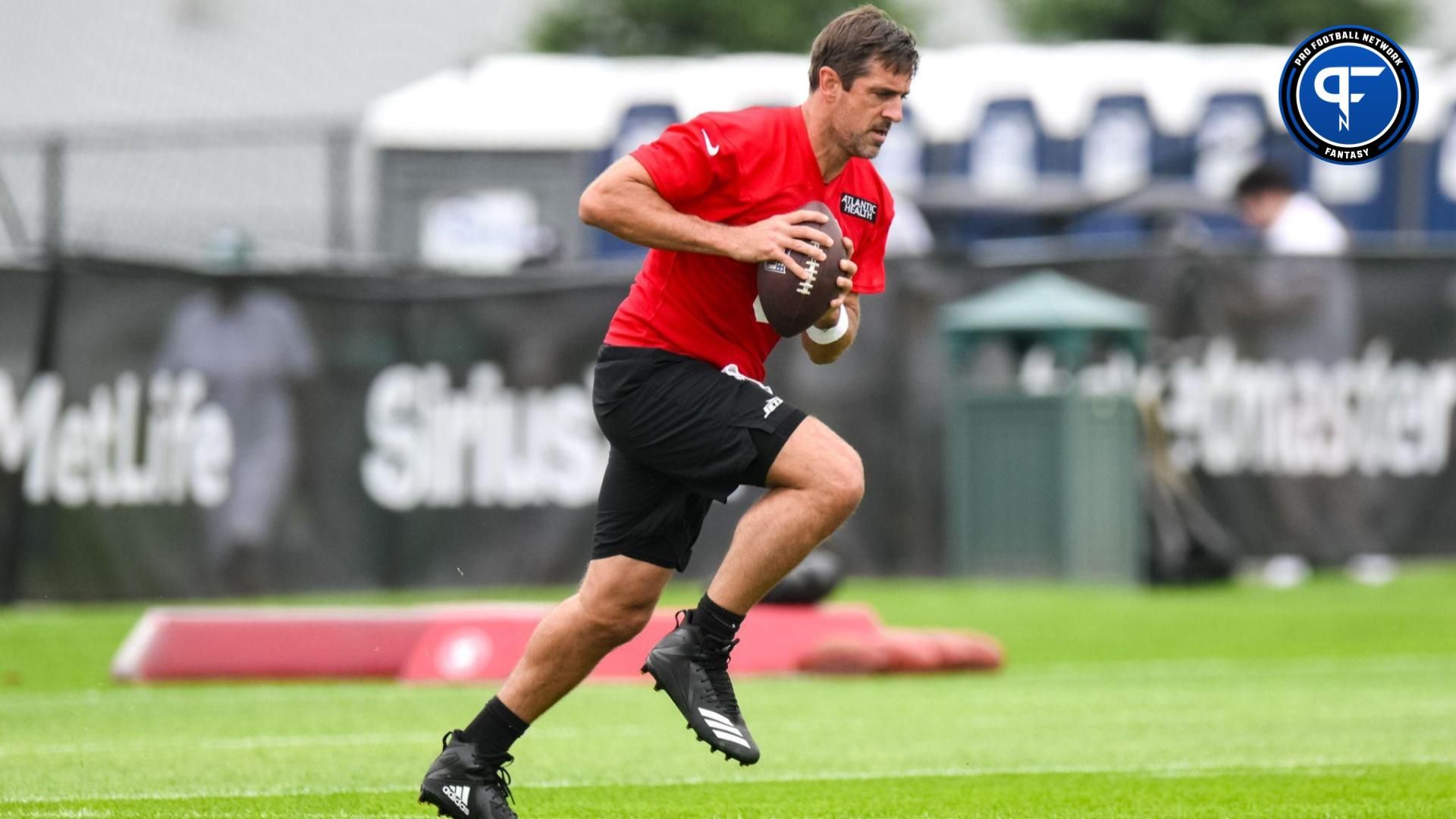 New York Jets QB Aaron Rodgers (8) runs a drill during practice at training camp.