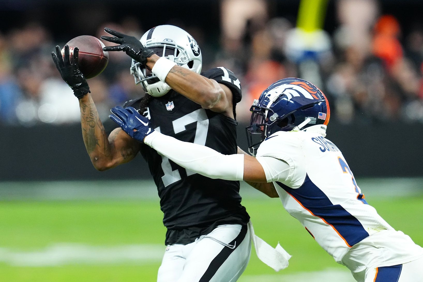 Las Vegas Raiders wide receiver Davante Adams (17) makes a catch against Denver Broncos cornerback Pat Surtain II (2) during the second quarter at Allegiant Stadium. Adams could use a change of scenery after two years in Las Vegas. Mandatory Credit: Stephen R. Sylvanie-USA TODAY Sports