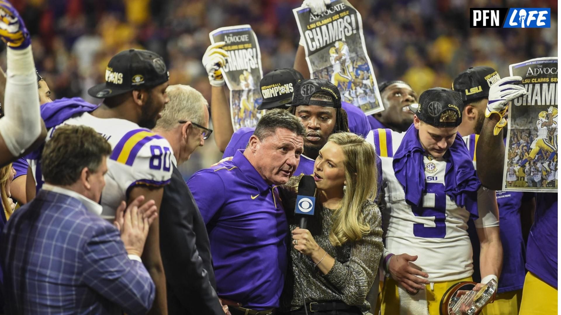 LSU Tigers head coach Ed Orgeron (center) talks with CBS reporter Jamie Erdahl (Sam Buckman's wife) after his team defeated the Georgia Bulldogs in the 2019 SEC Championship Game at Mercedes-Benz Stadium.