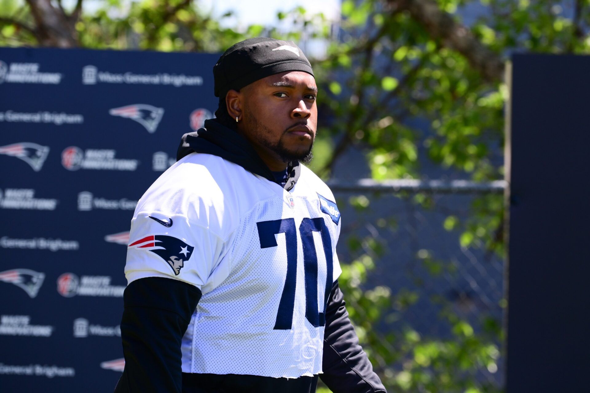 New England Patriots OT Caedan Wallace (70) walks to the practice fields for minicamp.