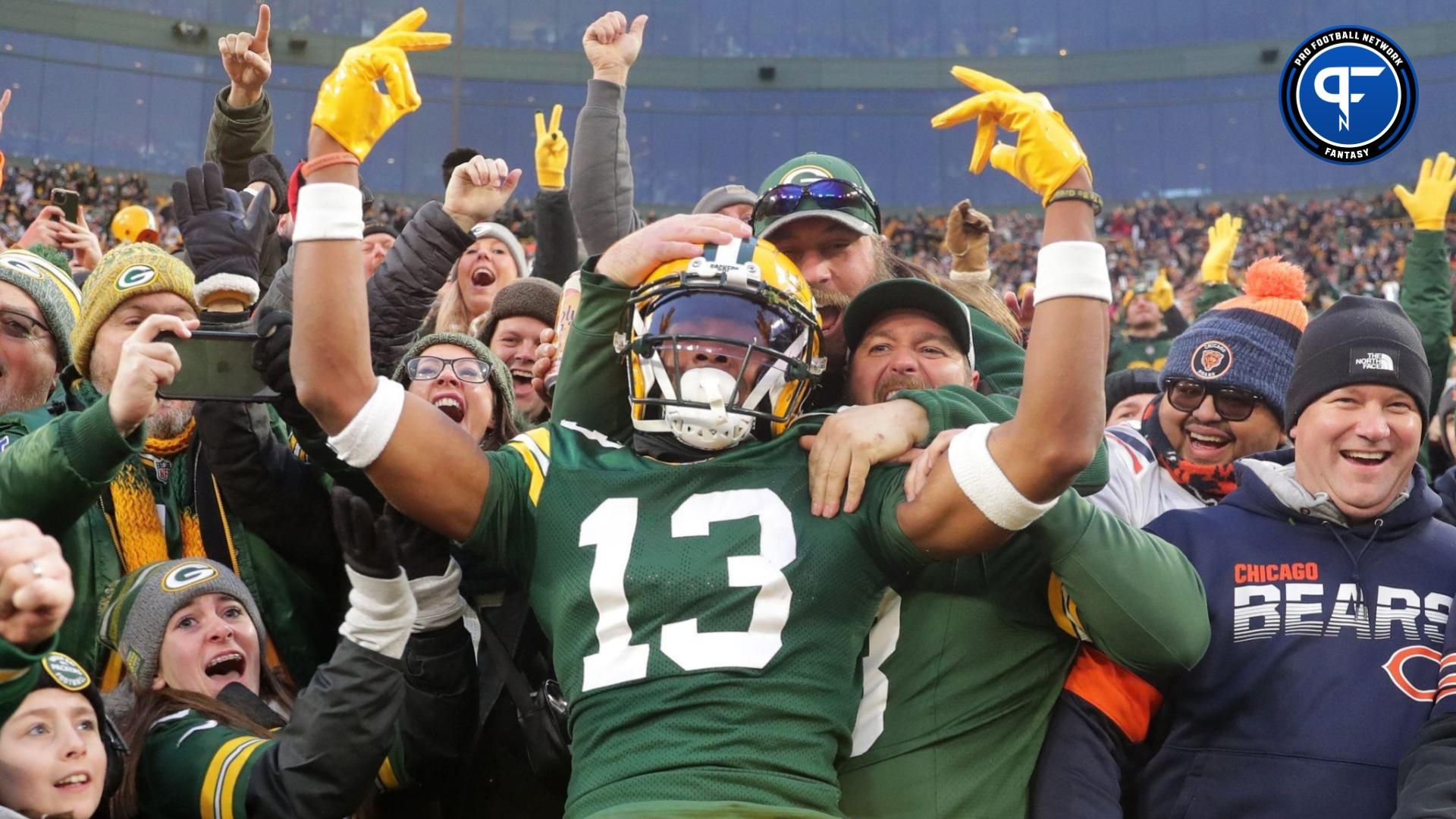 Green Bay Packers wide receiver Dontayvion Wicks (13) celebrates after catching a touchdown pass against Chicago Bears cornerback Terell Smith (32) during their football game Sunday, January 7, 2024, at Lambeau Field in Green Bay, Wis.