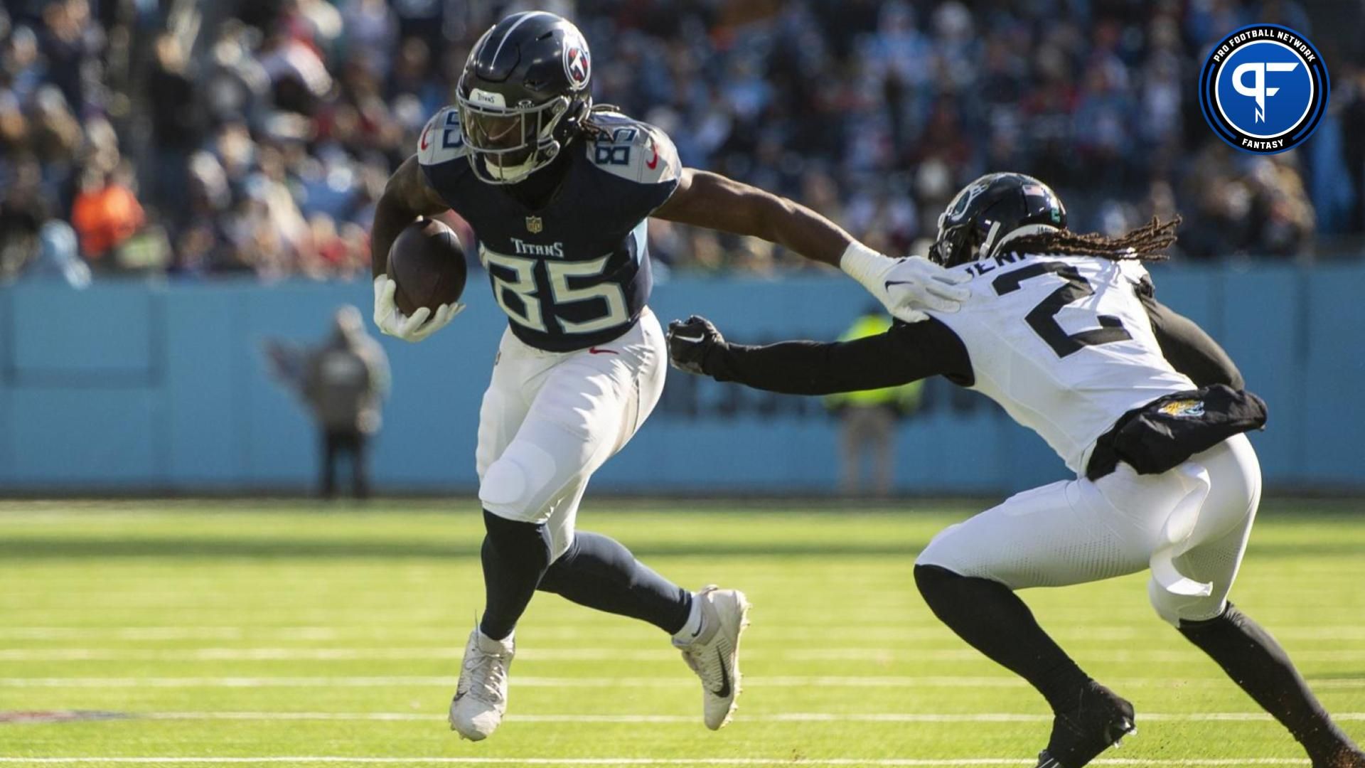 Tennessee Titans tight end Chigoziem Okonkwo (85) stiff arms Jacksonville Jaguars safety Rayshawn Jenkins (2) during the first half at Nissan Stadium.