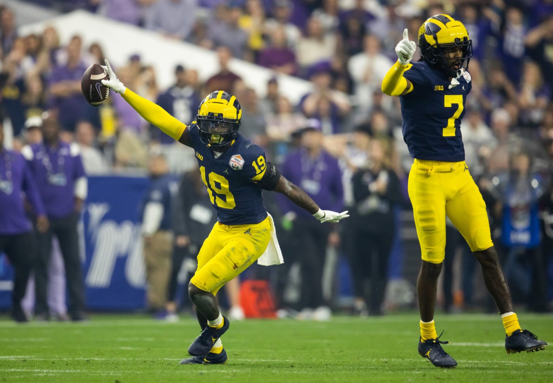 Michigan Wolverines defensive back Rod Moore (19) celebrates an interception against the TCU Horned Frogs during the 2022 Fiesta Bowl at State Farm Stadium.