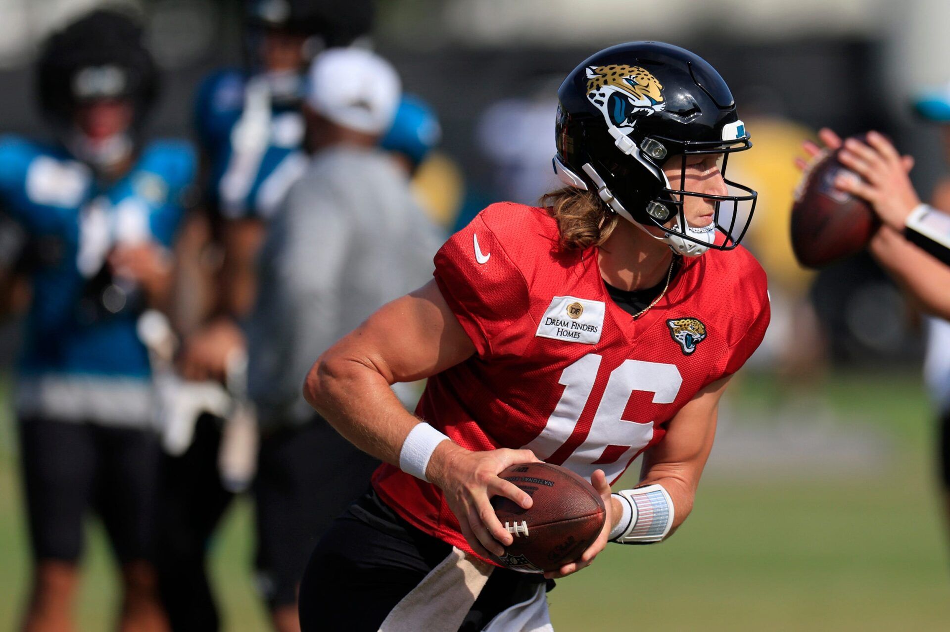 Jacksonville Jaguars quarterback Trevor Lawrence (16) looks to handoff during the seventh day of an NFL football training camp practice Wednesday, July 31, 2024 at EverBank Stadium’s Miller Electric Center in Jacksonville, Fla.