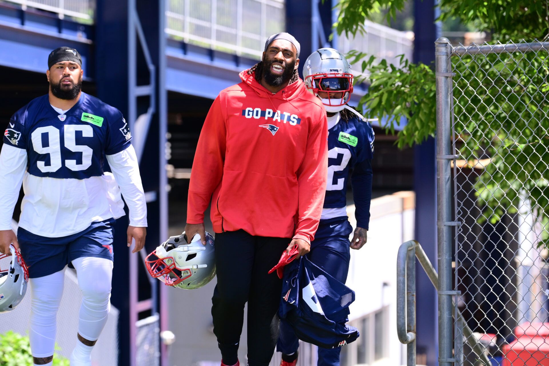 Jun 10, 2024; Foxborough, MA, USA; New England Patriots linebacker Matthew Judon (9) (red) heads to the practice field at minicamp at Gillette Stadium. Mandatory Credit: Eric Canha-USA TODAY Sports