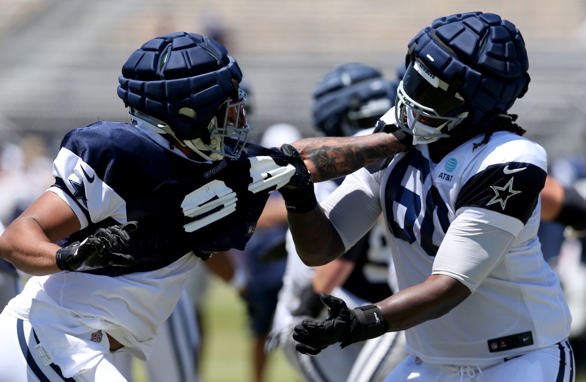 Jul 30, 2024; Oxnard, CA, USA; Dallas Cowboys defensive end Marshawn Kneeland (94) and offensive tackle Tyler Guyton (60) battle during training camp at the River Ridge Playing Fields in Oxnard, California. Mandatory Credit: Jason Parkhurst-USA TODAY Sports