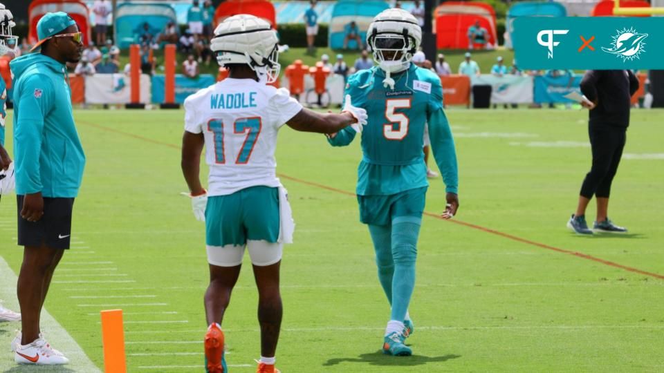 Jul 28, 2024; Miami Gardens, FL, USA; Miami Dolphins cornerback Jalen Ramsey (5) and wide receiver Jaylen Waddle (17) shake hands during training camp at Baptist Health Training Complex. Mandatory Credit: Sam Navarro-USA TODAY Sports