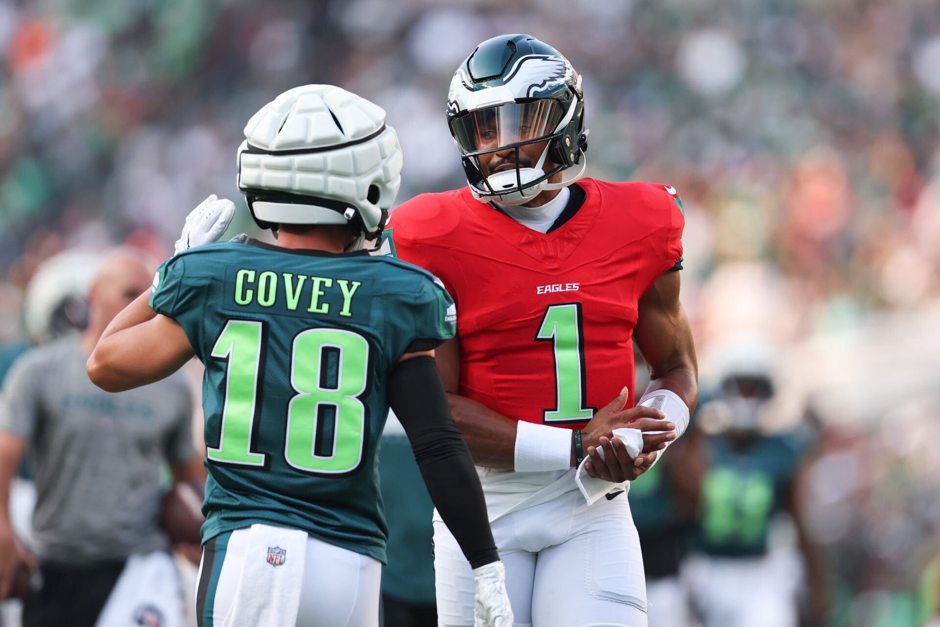 Philadelphia Eagles quarterback Jalen Hurts (1) talks with wide receiver Britain Covey (18) during a training camp practice at Lincoln Financial Field.