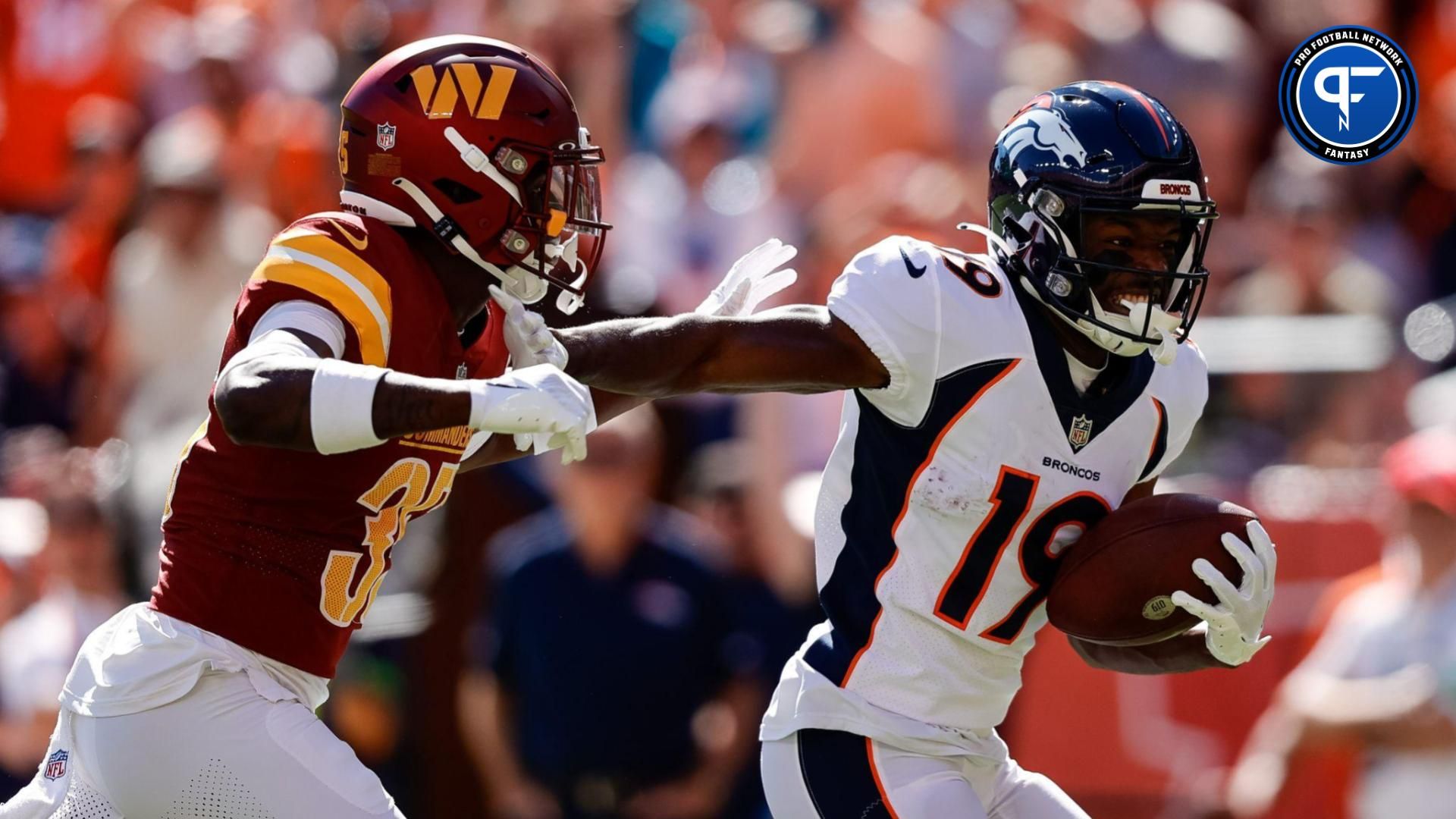 Sep 17, 2023; Denver, Colorado, USA; Denver Broncos wide receiver Marvin Mims Jr. (19) runs for a touchdown against Washington Commanders safety Percy Butler (35) after a catch in the first quarter at Empower Field at Mile High. Mandatory Credit: Isaiah J. Downing-USA TODAY Sports