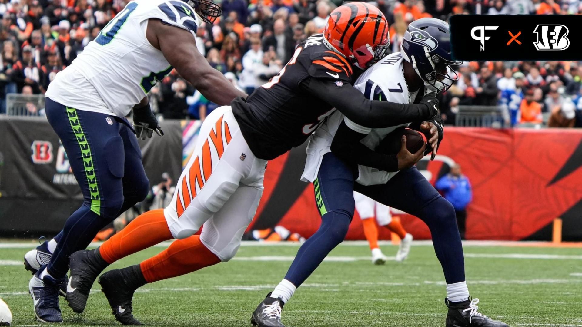 Cincinnati Bengals Cam Sample (96) takes down Seattle Seahawks quarterback Geno Smith (7) during their game against the Seattle Seahawks at Paycor Stadium on Sunday October 15, 2023. Bengals were up 14-10 at halftime.