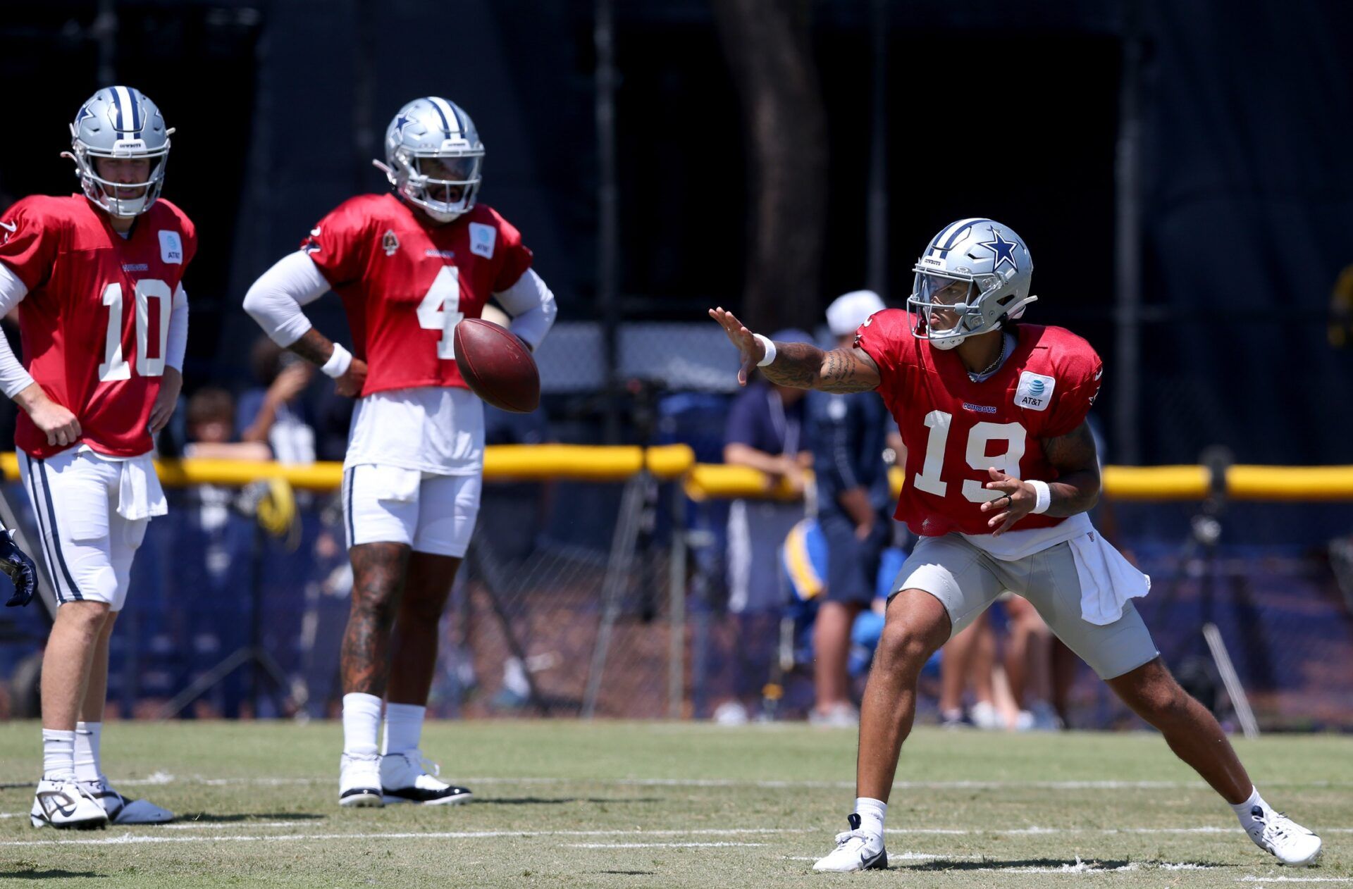 Dallas Cowboys quarterback Trey Lance (19) pitches in front of quarterback Cooper Rush (10) and quarterback Dak Prescott (4) during training camp at the River Ridge Playing Fields in Oxnard, California.