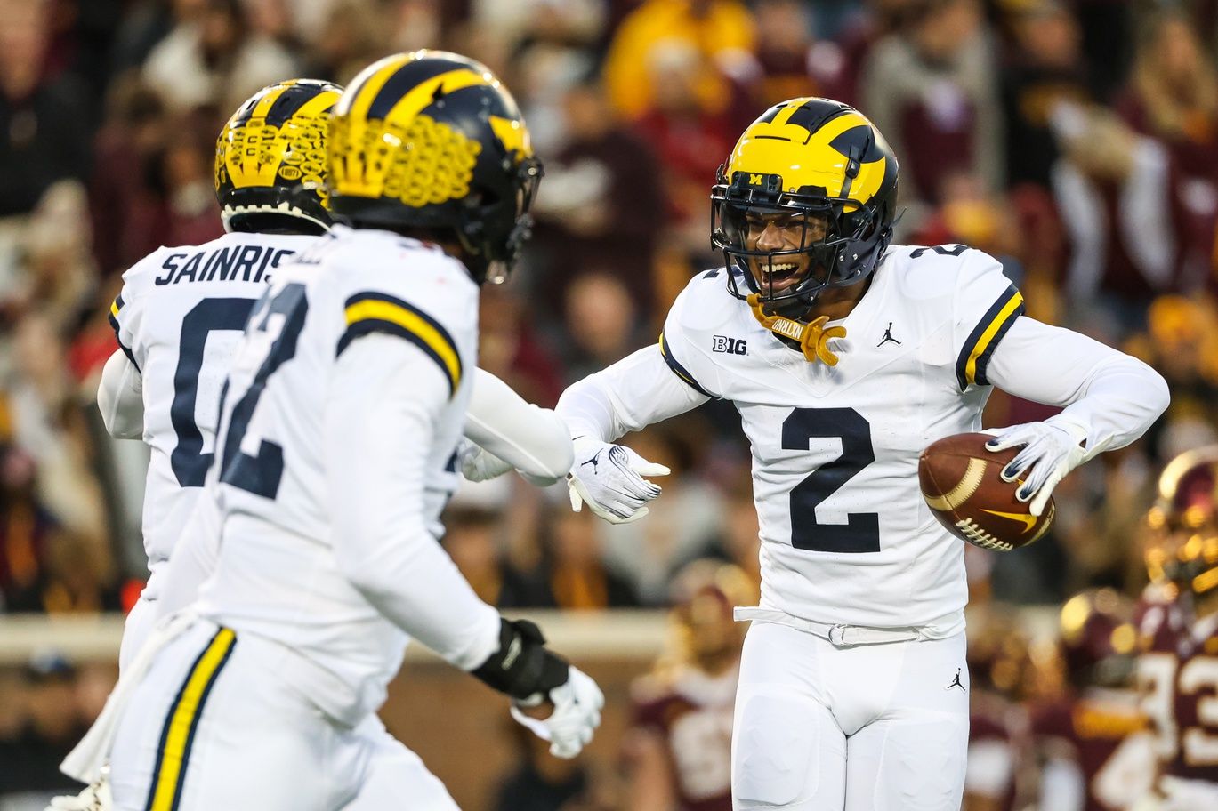 Michigan Wolverines defensive back Will Johnson (2) celebrates after returning an interception for a touchdown against the Minnesota Golden Gophers during the first quarter at Huntington Bank Stadium. Mandatory Credit: Matt Krohn-USA TODAY Sports