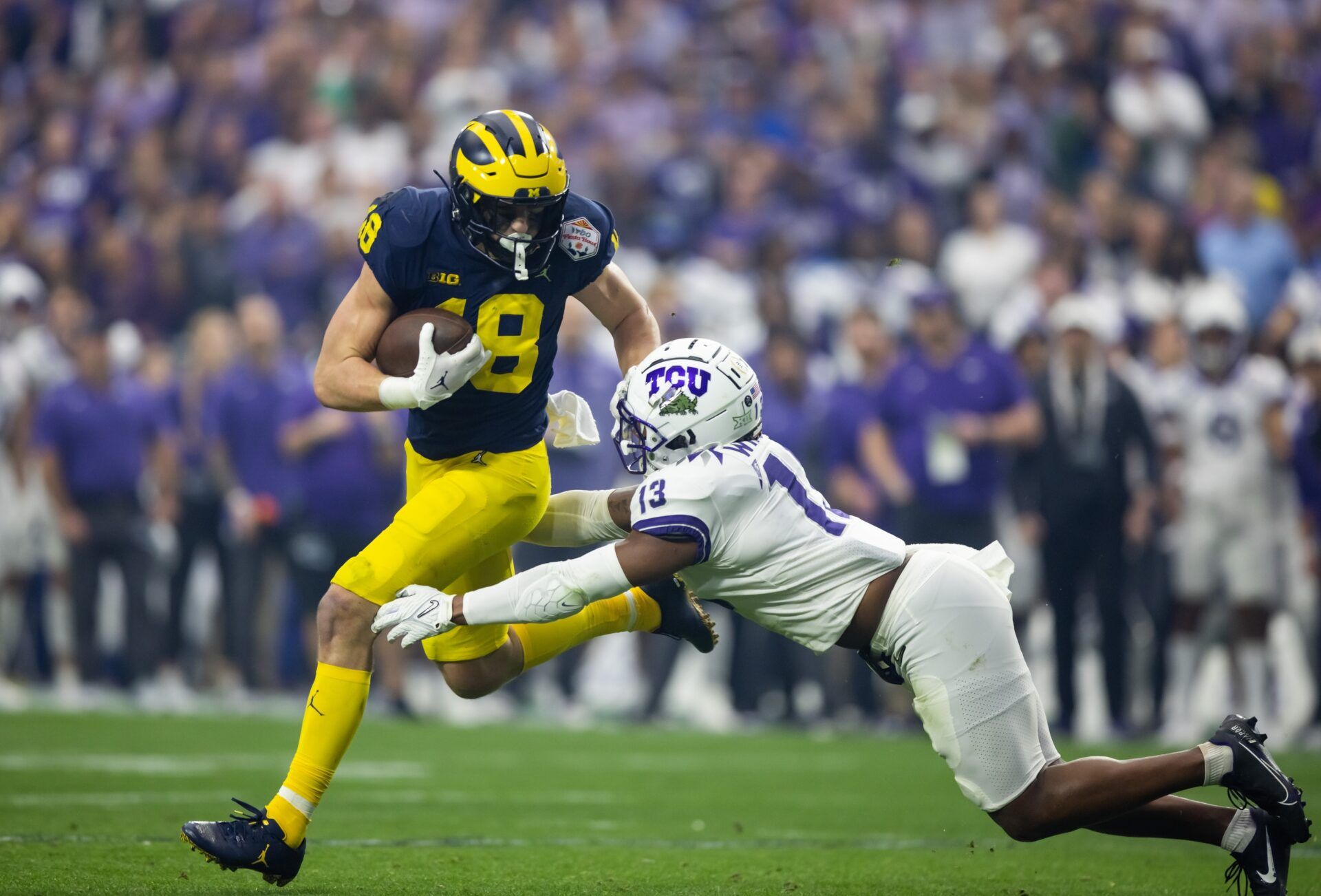 Michigan Wolverines tight end Colston Loveland (18) against TCU Horned Frogs linebacker Dee Winters (13) during the 2022 Fiesta Bowl at State Farm Stadium. Mandatory Credit: Mark J. Rebilas-USA TODAY Sports