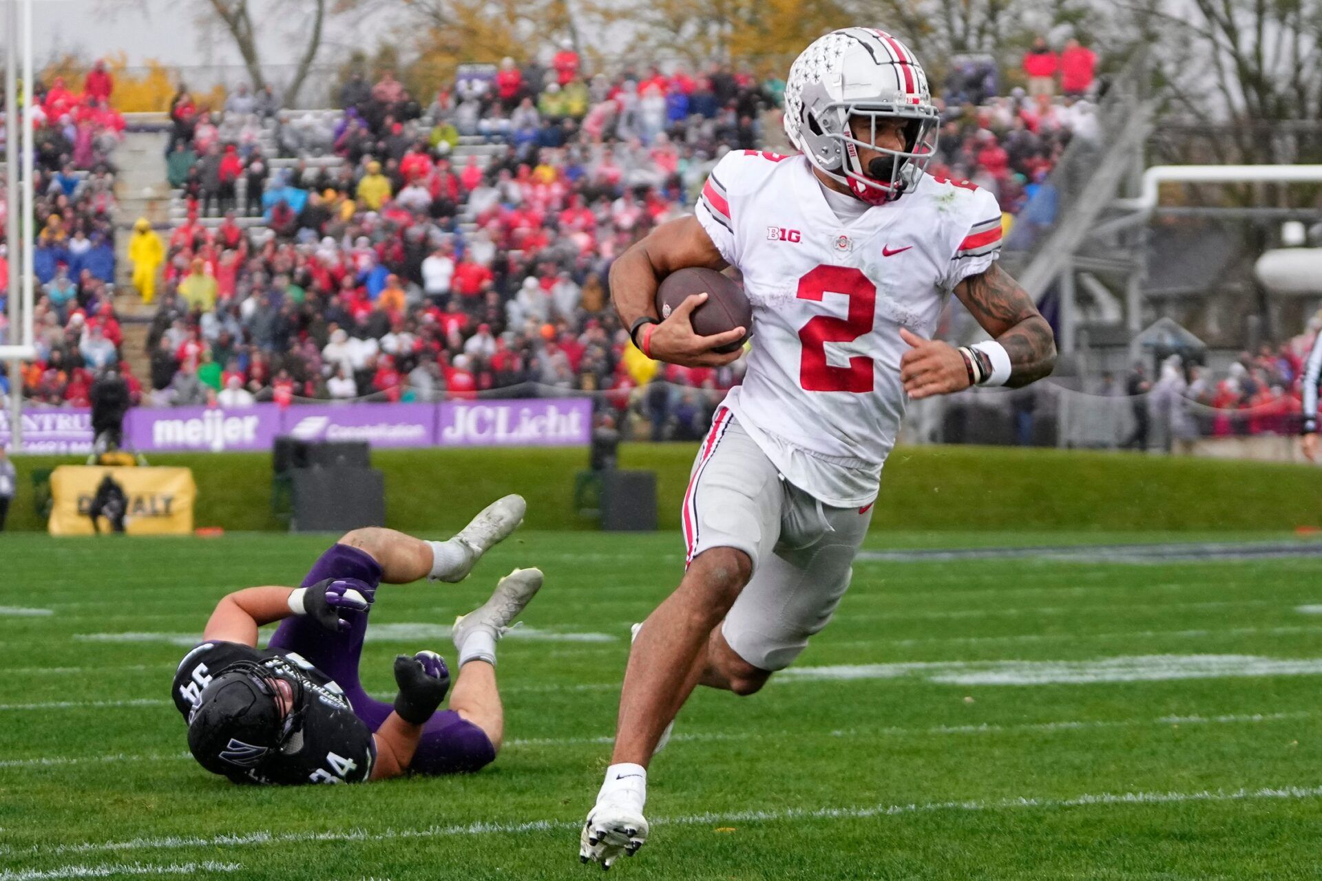 Ohio State Buckeyes wide receiver Emeka Egbuka (2) runs past Northwestern Wildcats linebacker Xander Mueller (34) on his way to a touchdown during the second half of the NCAA football game at Ryan Field. Mandatory Credit: Adam Cairns-The Columbus Dispatch Ncaa Football Ohio State Buckeyes At Northwestern Wildcats