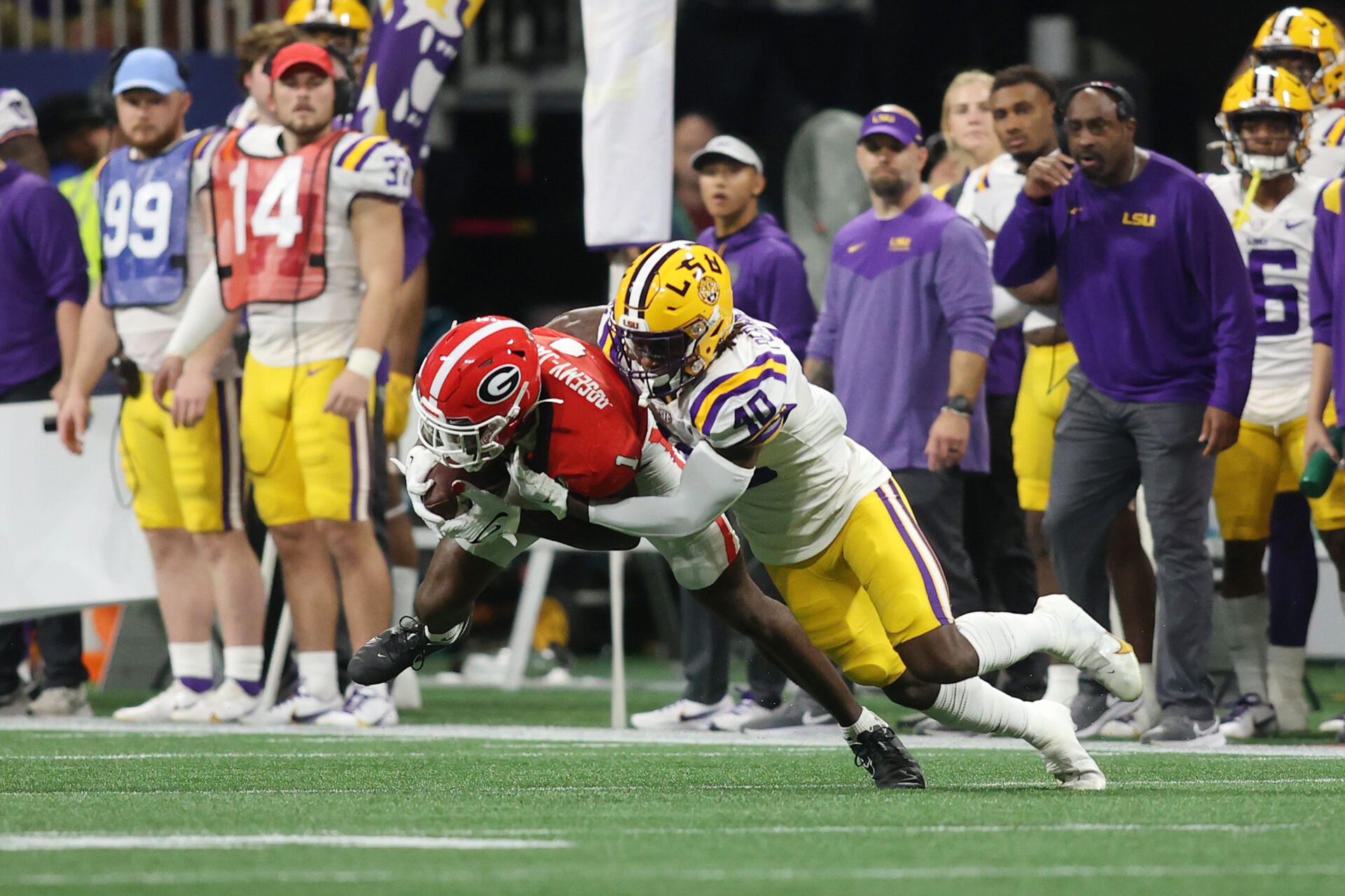 Dec 3, 2022; Atlanta, GA, USA; Georgia Bulldogs wide receiver Marcus Rosemy-Jacksaint (1) is hit following his reception by LSU Tigers linebacker Harold Perkins Jr. (40) during the second quarter at Mercedes-Benz Stadium. Mandatory Credit: Brett Davis-USA TODAY Sports