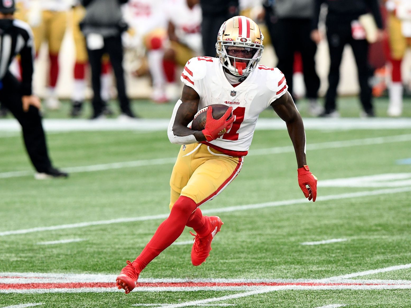 San Francisco 49ers wide receiver Brandon Aiyuk (11) runs with the ball against the New England Patriots during the first half at Gillette Stadium.