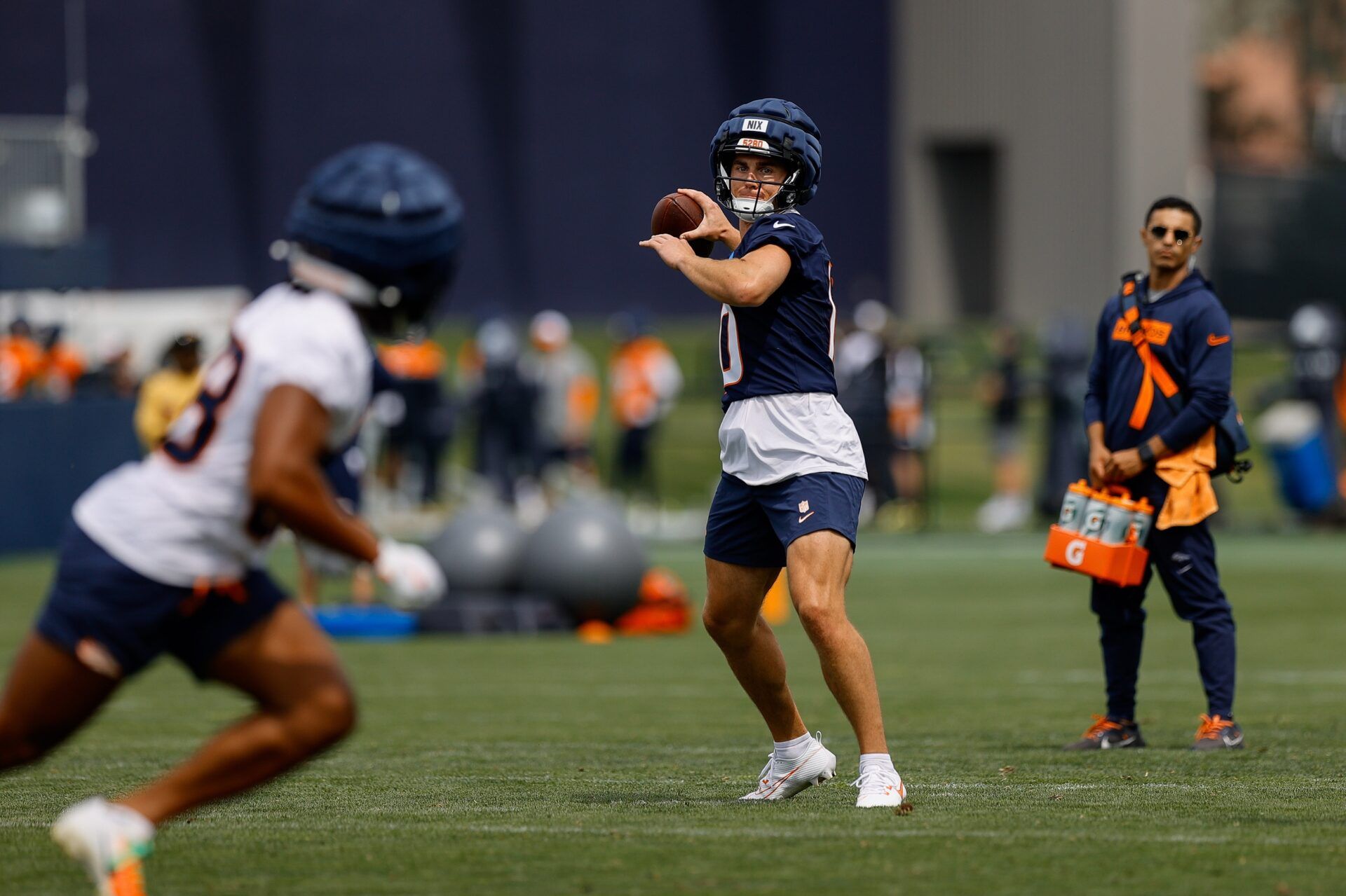 Denver Broncos QB Bo Nix (10) throws a pass during training camp.