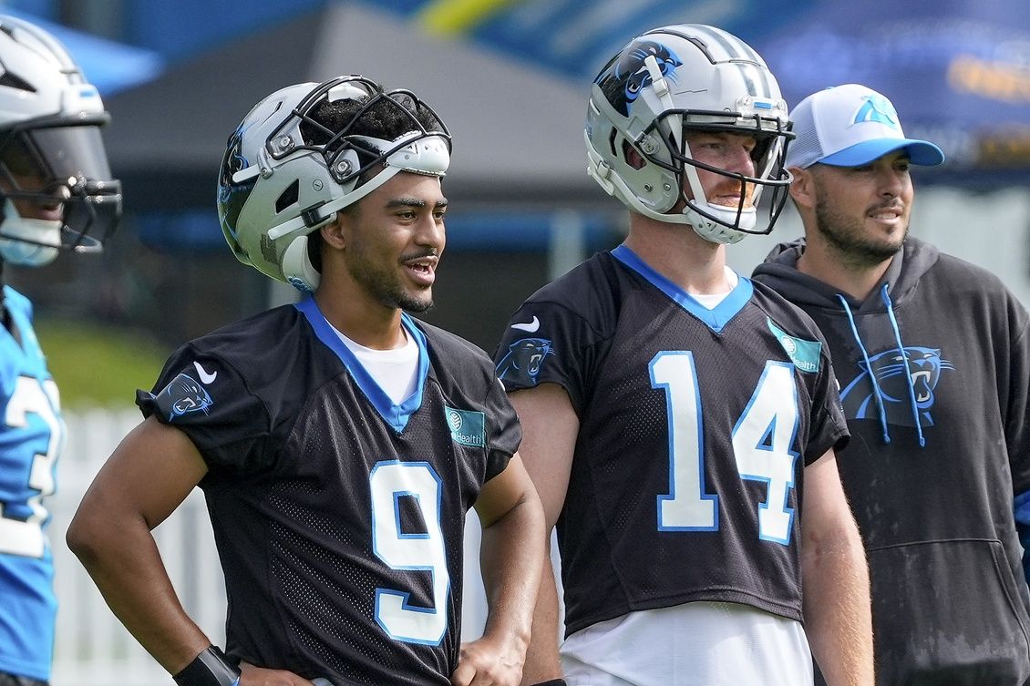 Carolina Panthers quarterback Bryce Young (9) and quarterback Andy Dalton (14) watch practice at Carolina Panthers Practice Fields.