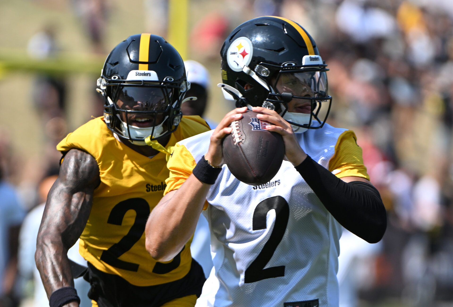 Jul 28, 2024; Latrobe, PA, USA; Pittsburgh Steelers quarterback Justin Fields (2) is pressured by safety DeShon Elliott (25) during training camp at Saint Vincent College. Mandatory Credit: Barry Reeger-USA TODAY Sports