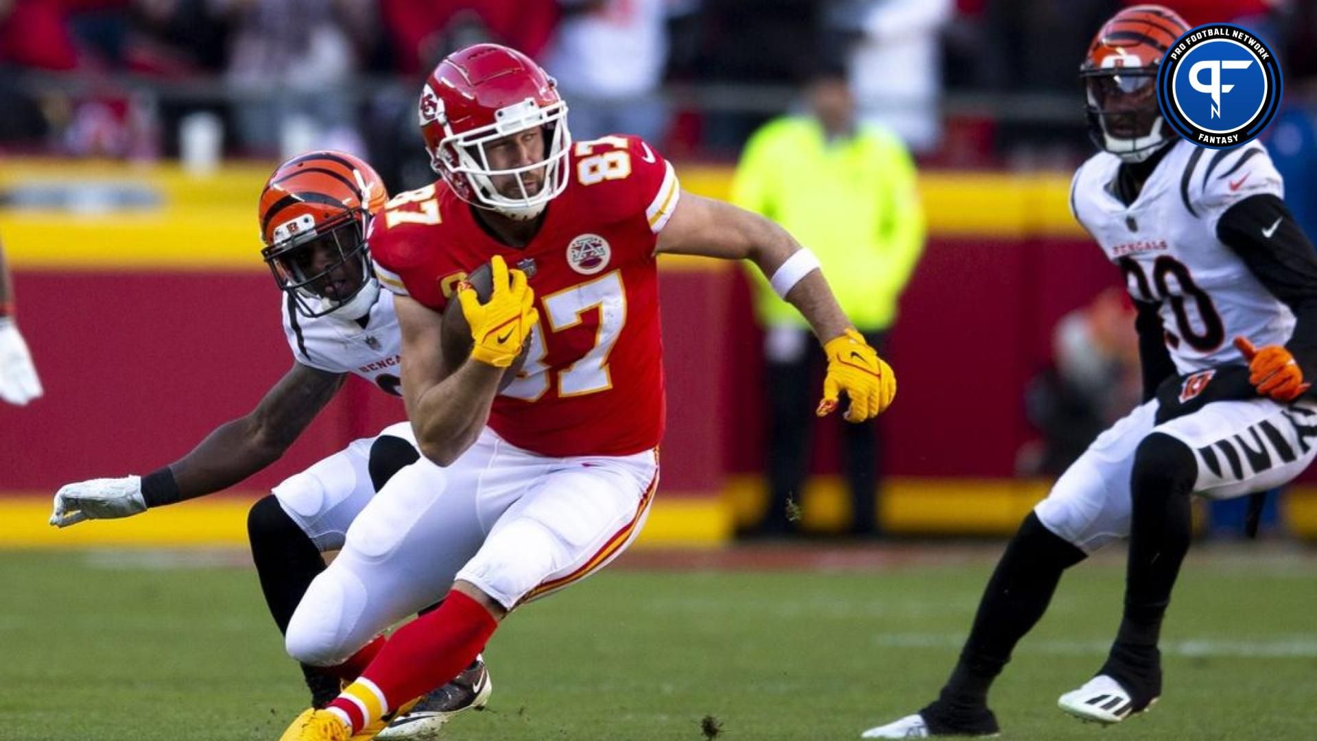 Kansas City Chiefs tight end Travis Kelce (87) catches a pass as Cincinnati Bengals cornerback Mike Hilton (21) defends in the second quarter during the AFC championship NFL football game, Sunday, Jan. 30, 2022, at GEHA Field at Arrowhead Stadium in Kansas City.