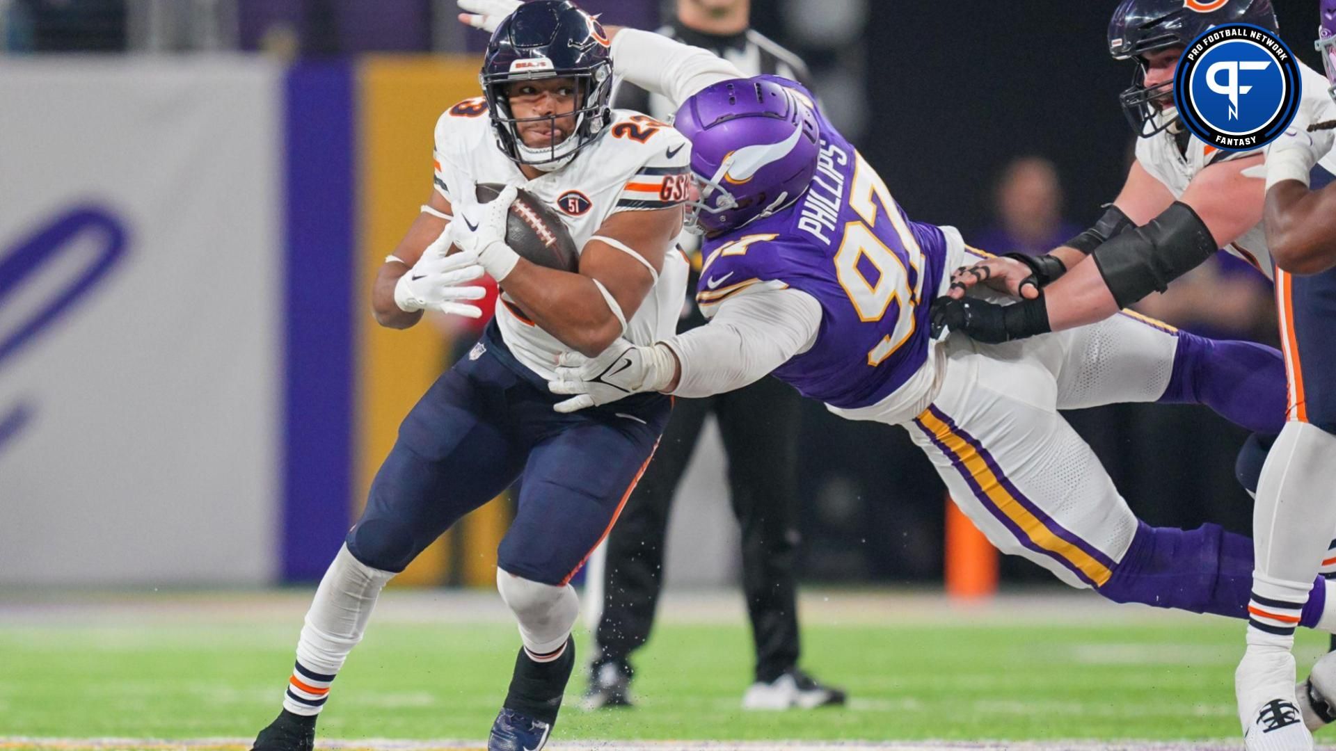 Chicago Bears running back Roschon Johnson (23) runs with the ball against the Minnesota Vikings defensive tackle Harrison Phillips (97) in the third quarter at U.S. Bank Stadium.