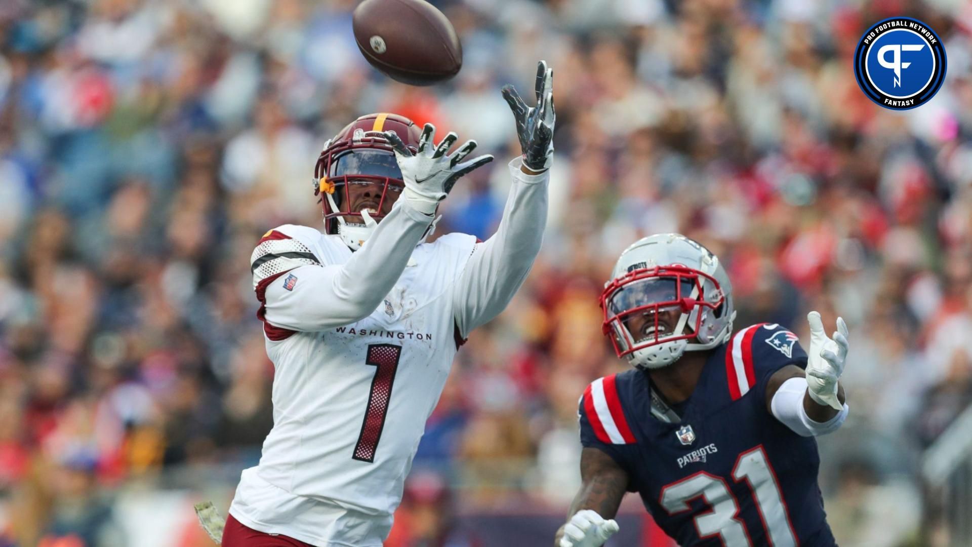 Washington Commanders receiver Jahan Dotson (1) catches a pass for a touchdown during the second half against the New England Patriots at Gillette Stadium.