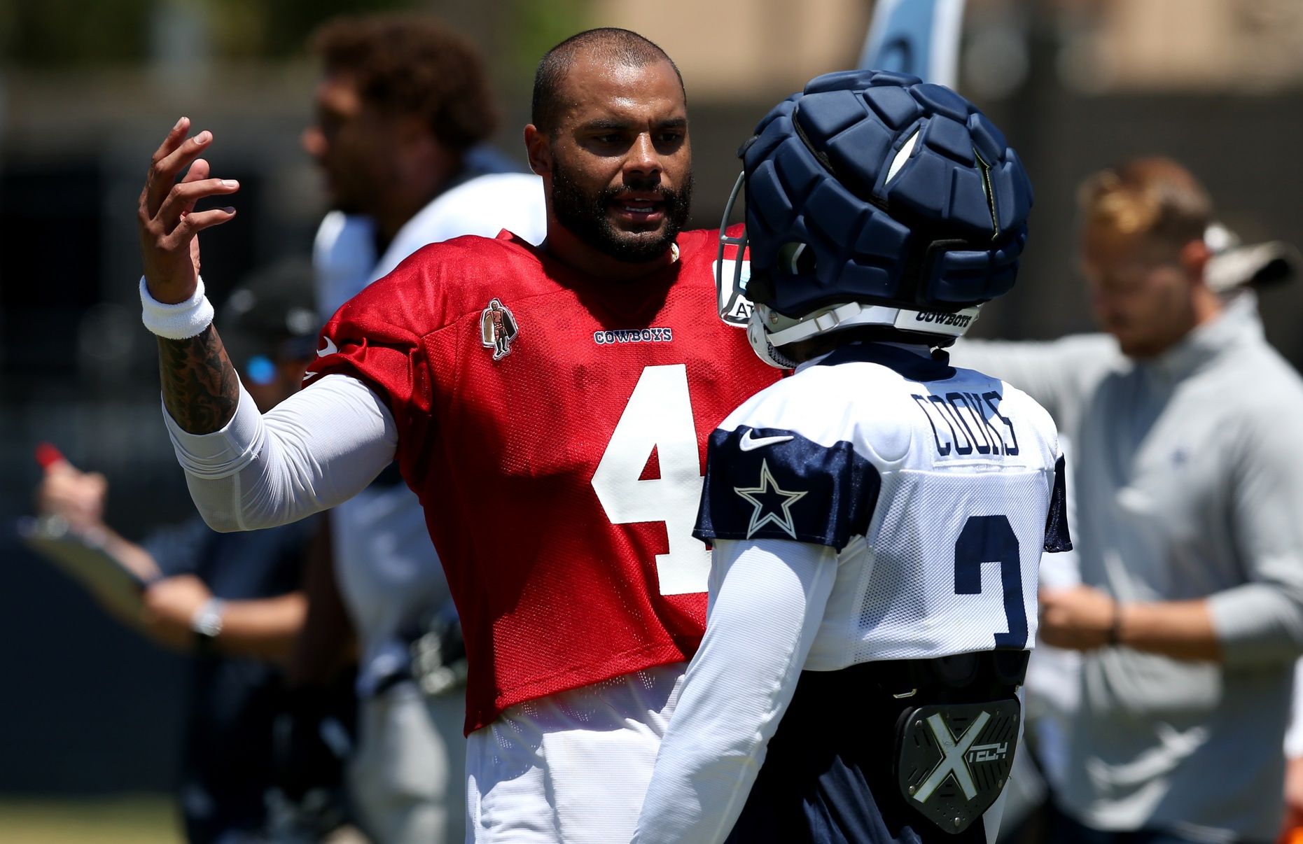 Dallas Cowboys quarterback Dak Prescott (4) talks to wide receiver Brandin Cooks (3) during training camp at the River Ridge Playing Fields in Oxnard, California. Mandatory Credit: Jason Parkhurst-USA TODAY Sports