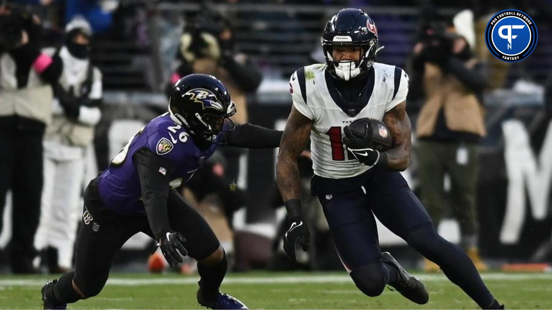 Houston Texans wide receiver Nico Collins (12) runs the ball against Baltimore Ravens safety Geno Stone (26) during the first quarter of a 2024 AFC divisional round game at M&T Bank Stadium. Collins is a top fantasy football player in 2024 in the AFC South. Mandatory Credit: Tommy Gilligan-USA TODAY Sports